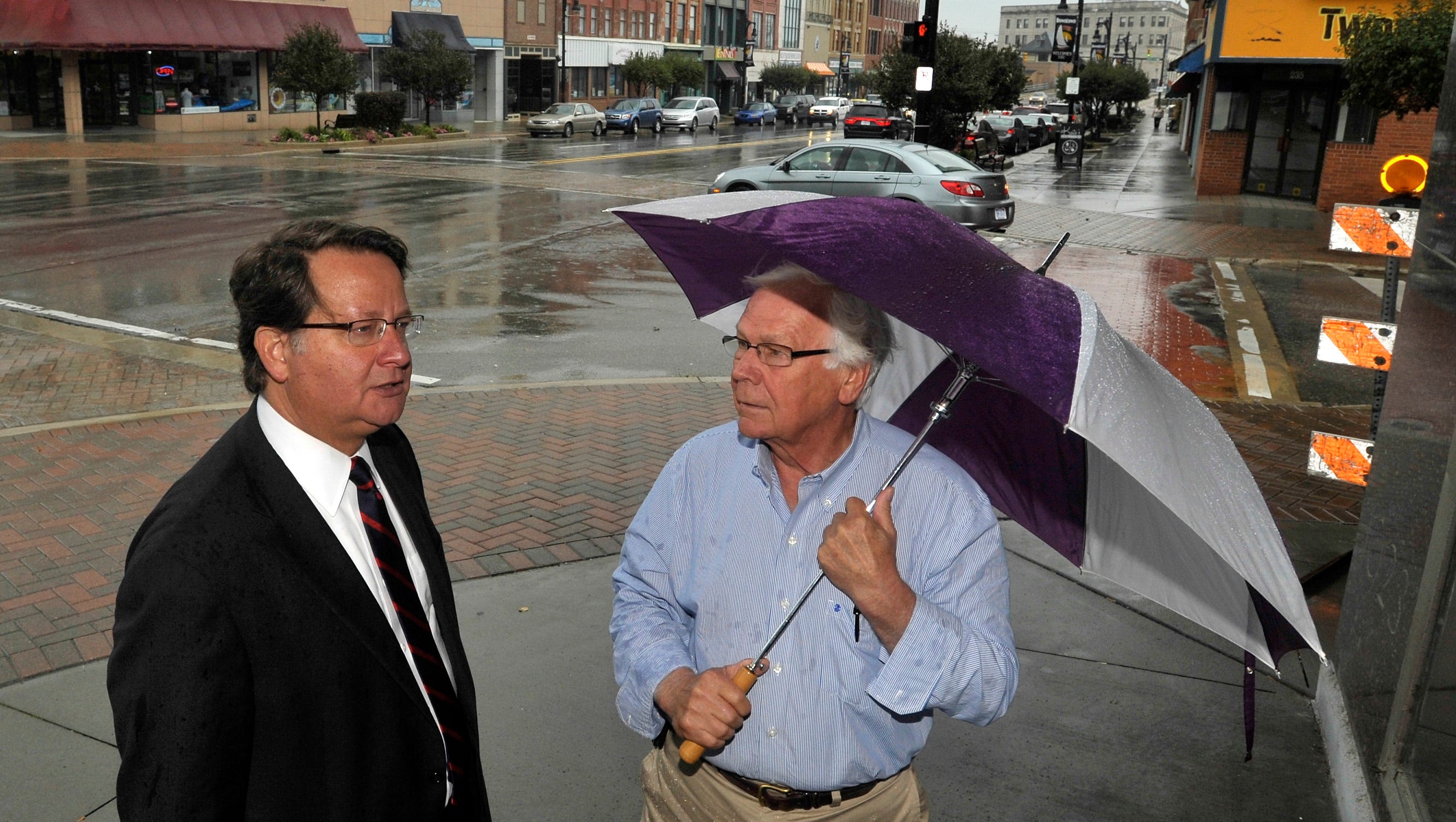 U.S. Congressman Gary Peters, left, talks with St. Clair County Commissioner Howard Heidemann in downtown Port Huron.