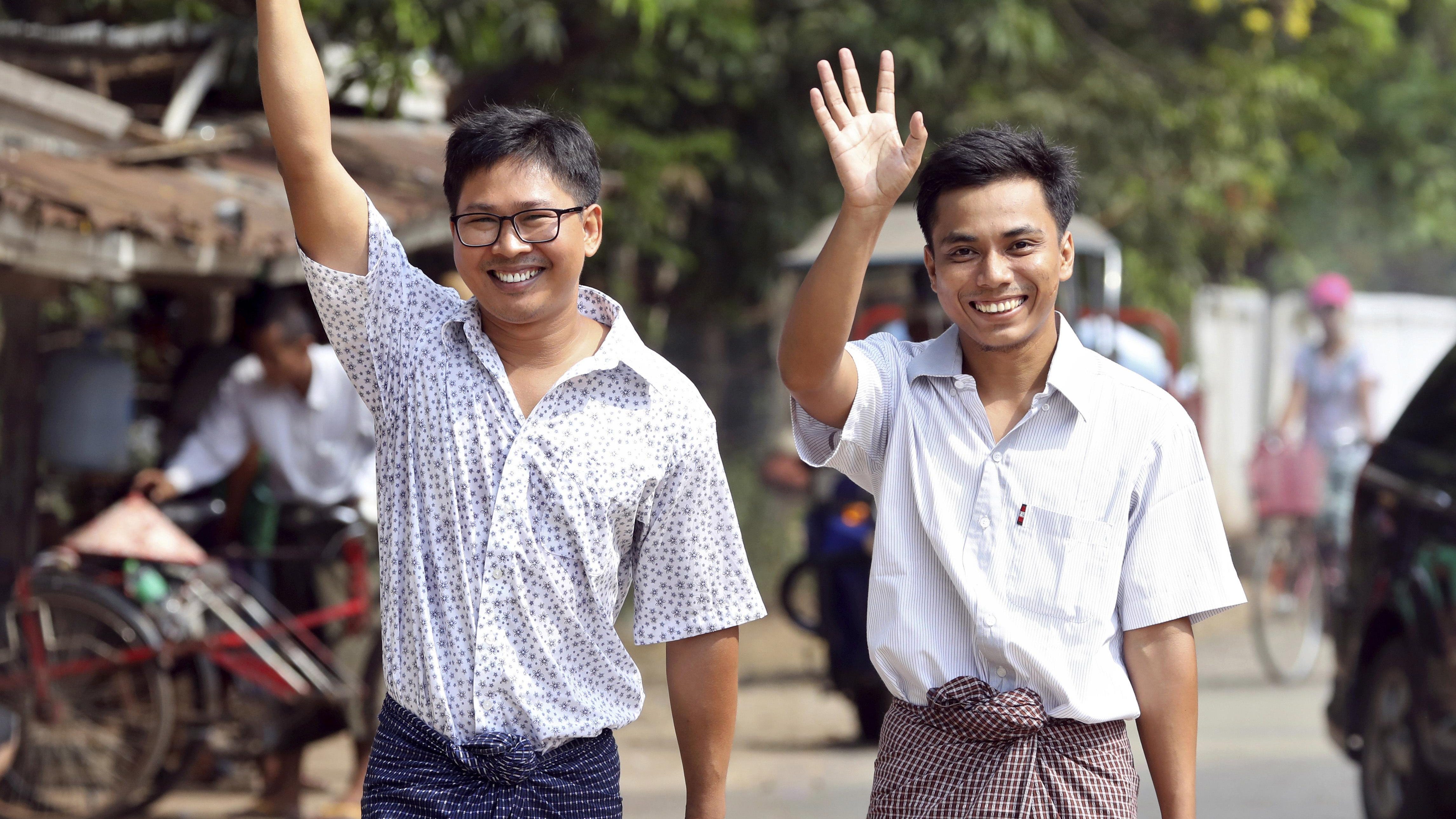 Reuters reporters Wa Lone, left, and Kyaw Soe Oo walk through the Insein Prison gate after being freed, in Yangon, Myanmar, Tuesday, May 7, 2019.