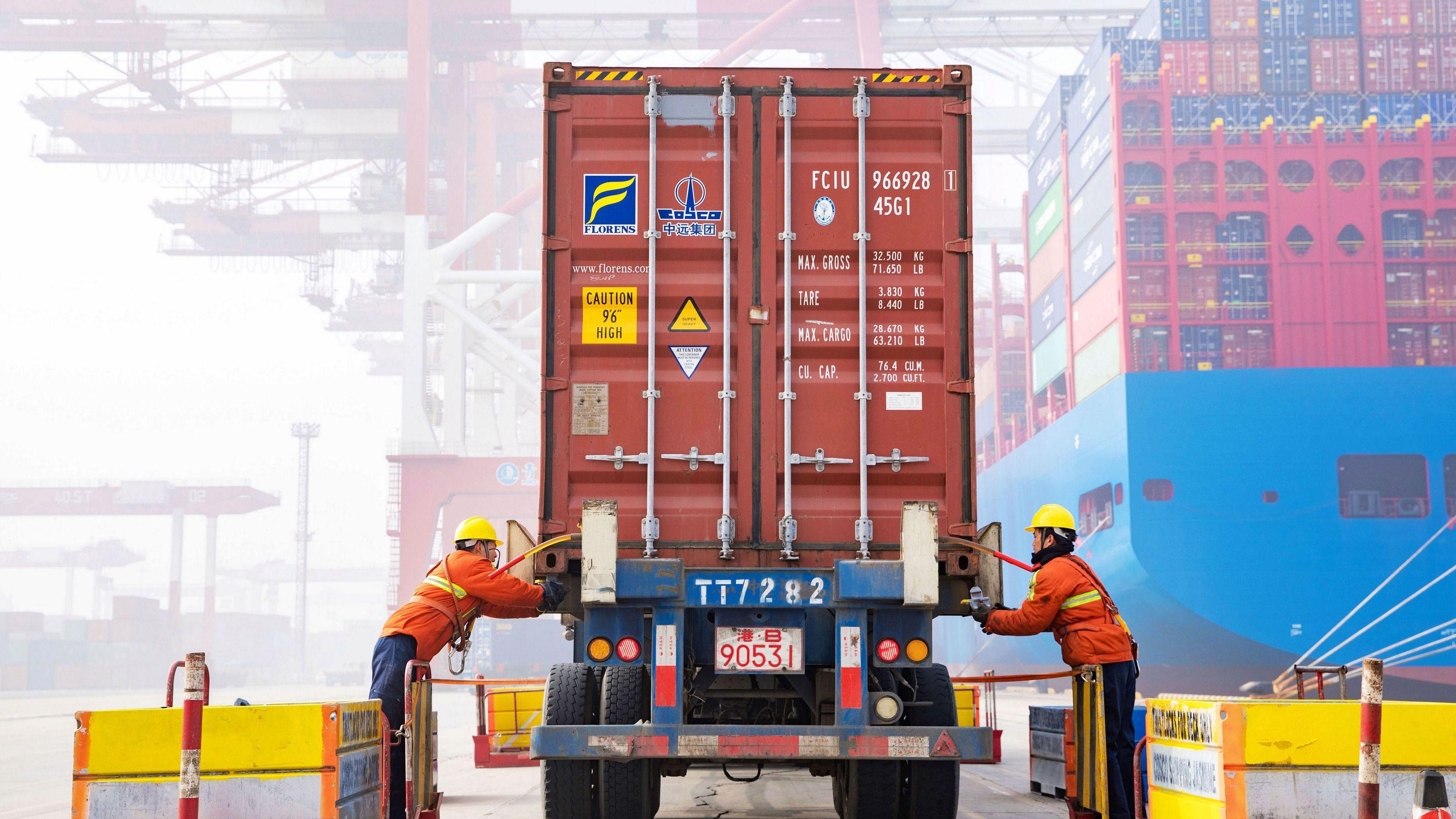 Workers prepare a container at the port in Qingdao, China's eastern Shandong province, on Jan. 14, 2019.
