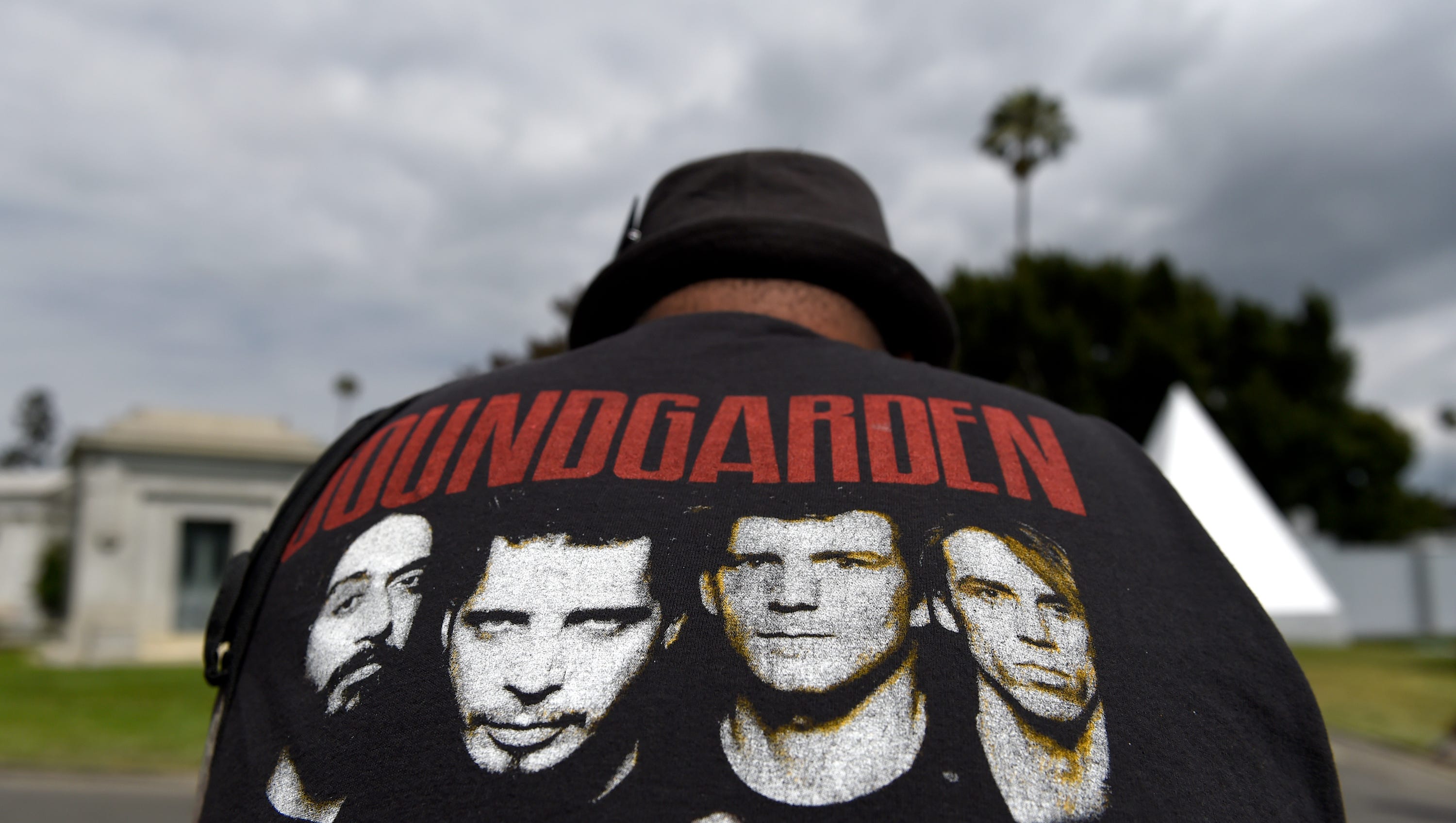 A fan wearing a Soundgarden T-shirt reacts following a funeral for Chris Cornell at the Hollywood Forever Cemetery in Los Angeles.