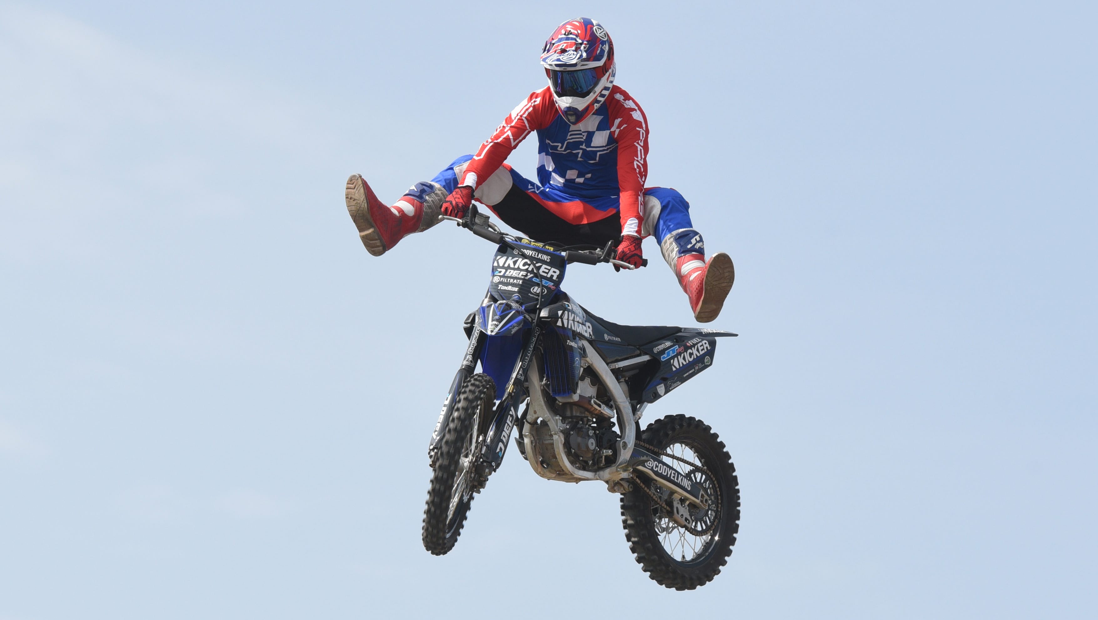A professional motocross rider kicks his heels up for the crowd during the Roadkill Nights event held at M1 Concourse in Pontiac on Saturday, August 11, 2018.