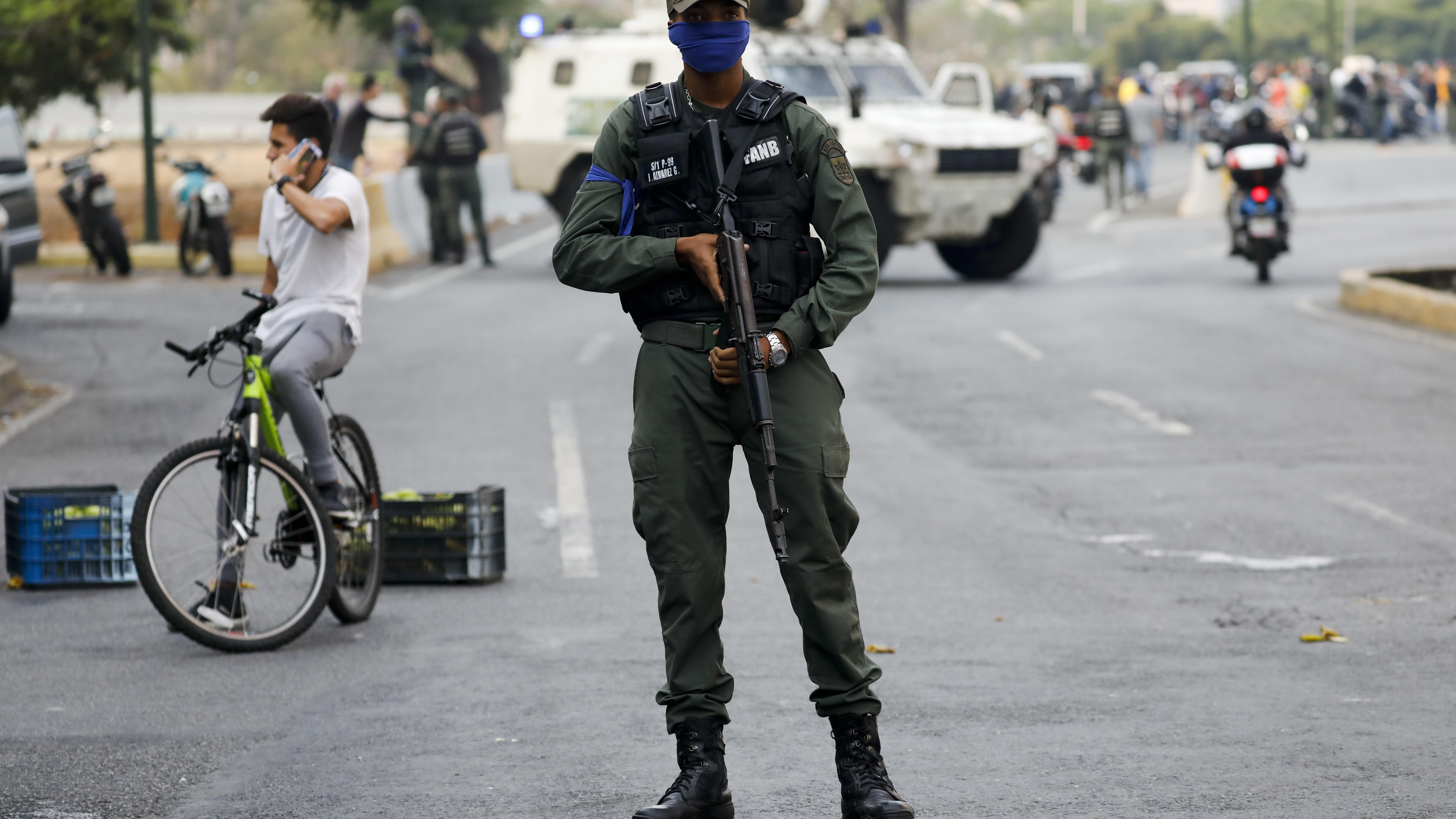 A soldier stands on an avenue leading to La Carlota air base in Caracas, Venezuela, Tuesday, April 30, 2019.