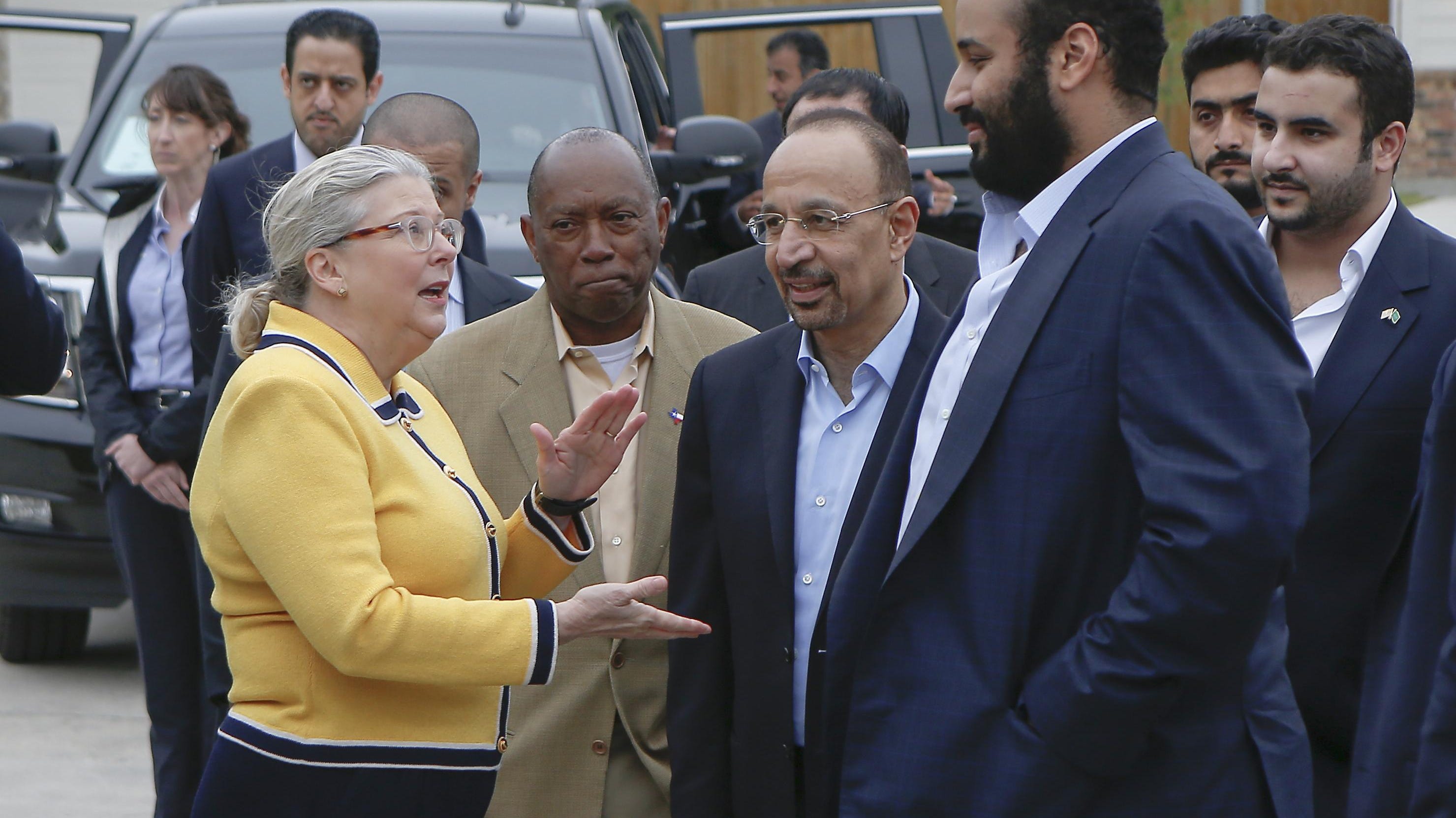 In this April 7, 2018, file photo, Saudi Crown Prince Mohammed bin Salman, right, is seen with his entourage as he tours a flood-damaged area in Houston, Texas. The man in the photo, rear second left, is allegedly the same individual in images that a pro-government Turkish newspaper published who was seen on surveillance video walking into the Saudi Consulate in Istanbul before writer Jamal Khashoggi vanished there.