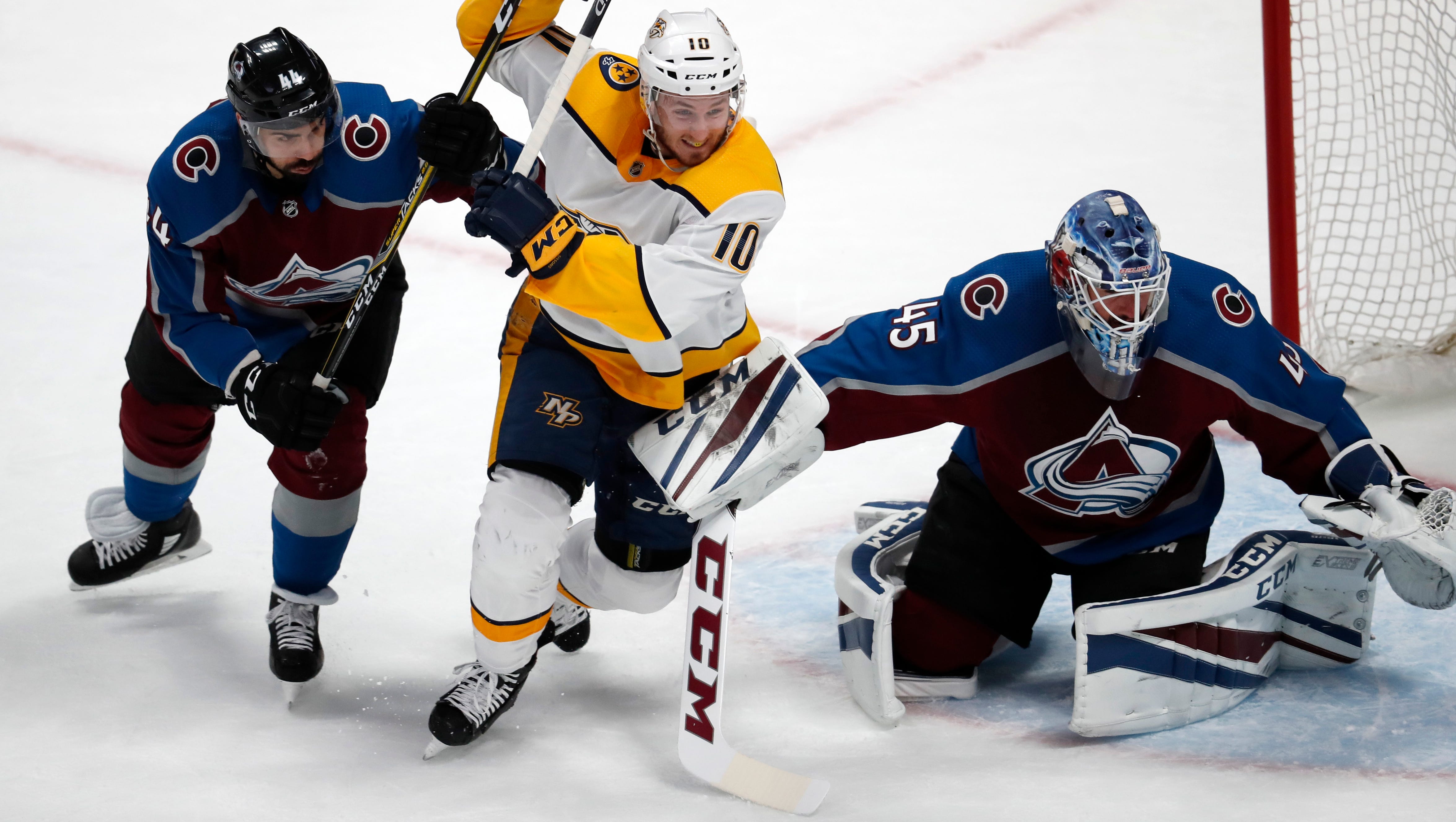 Nashville Predators center Colton Sissons fights to pursue the puck between Colorado Avalanche defenseman Mark Barberio, left, and goaltender Jonathan Bernier during the first period of Game 4 of a first-round playoff series Wednesday, April 18, 2018, in Denver.