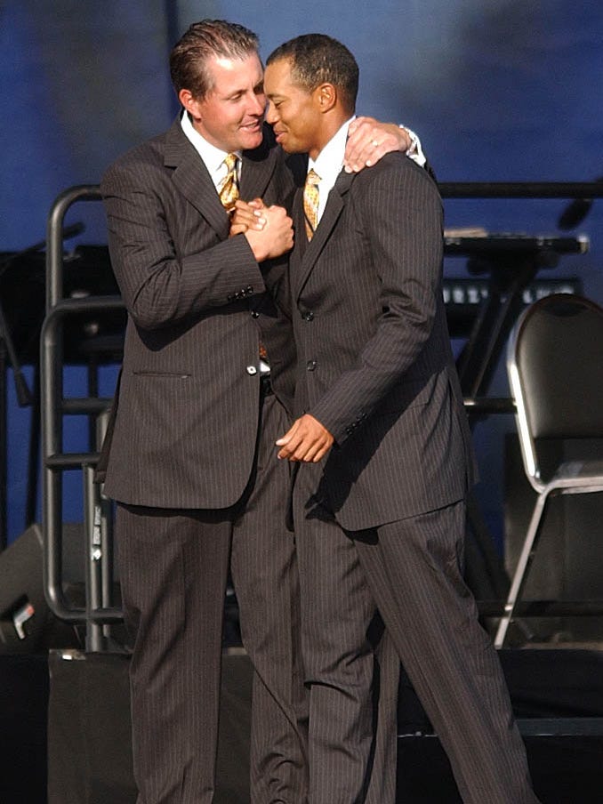 Phil Mickelson and Tiger Woods share an embrace during the pre-festivities at the 2004 Ryder Cup.