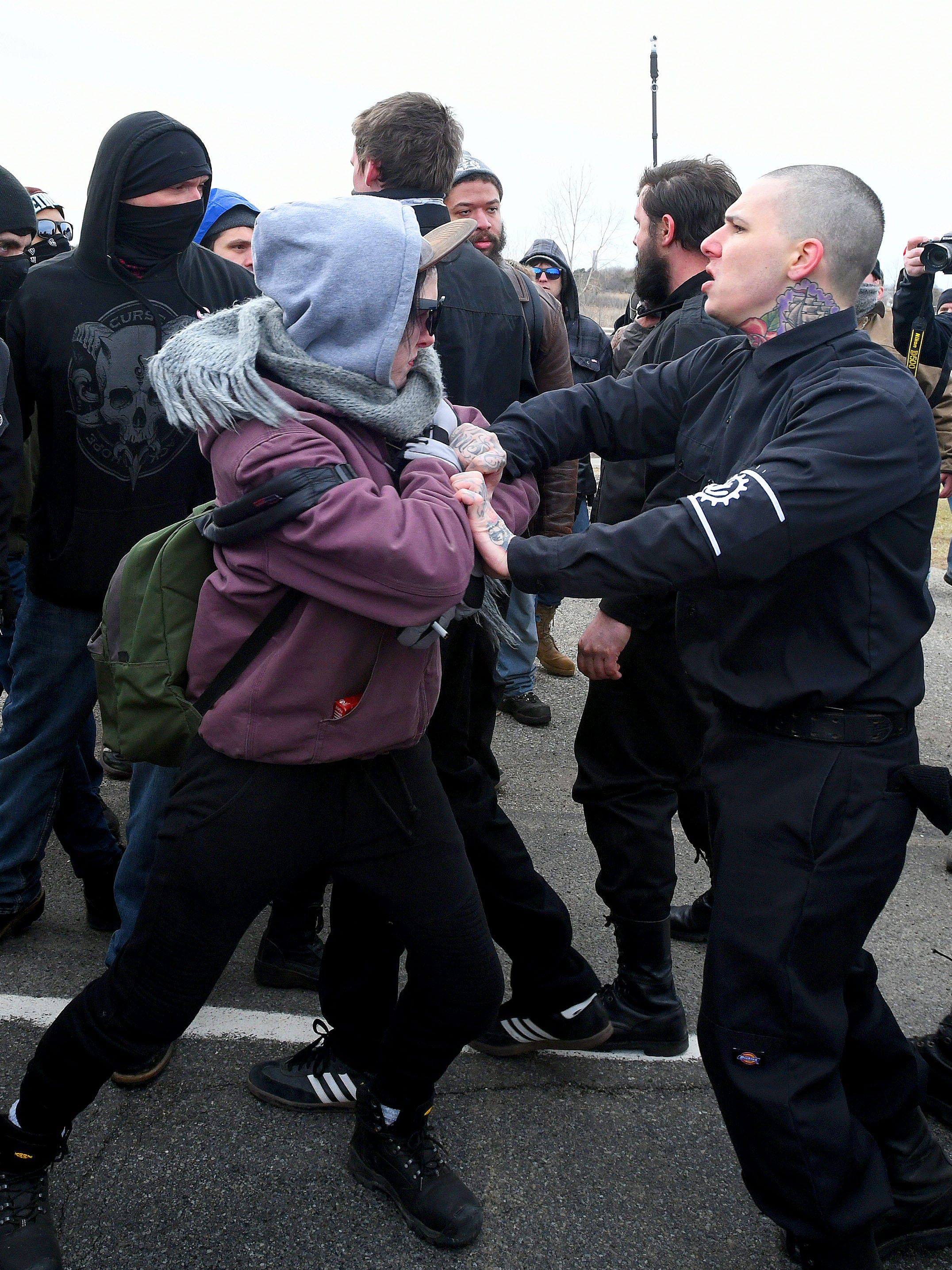 An anti-Richard Spencer protestor, left, clashes with a white nationalist. A group of Spencer sympathizers were trying to make their way to the MSU Pavilion and the protestors were trying to stop them on Michigan State University's campus in East Lansing on Monday, March 5, 2018.