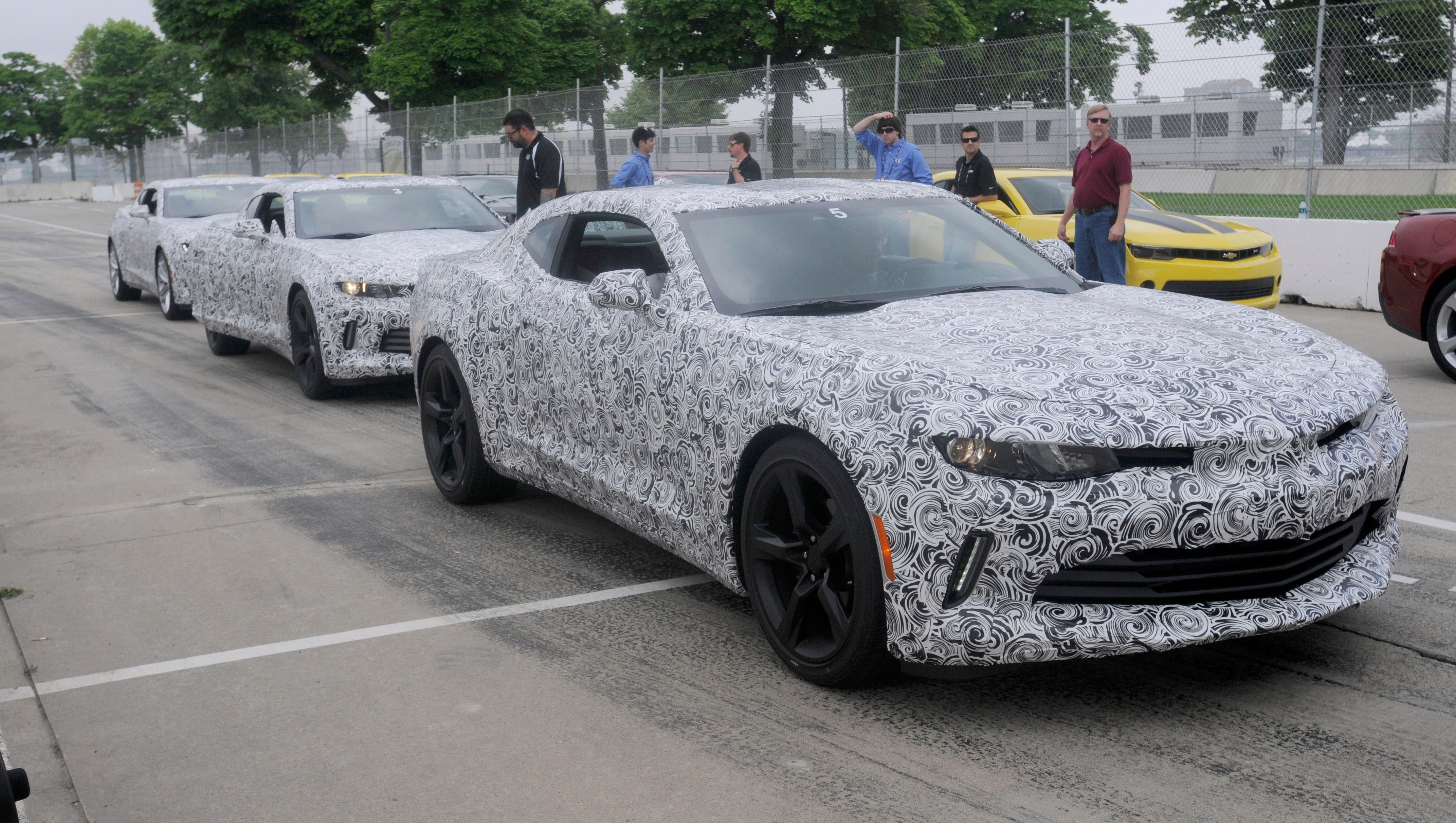 Several 2016 Camaro mule cars sit in pit lane during a test day with the new Chevrolet Camaro on the Grand Prix track at Belle Isle.