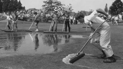 Warwick Hills groundskeepers work to get the water off the course during a 1980s playing of the Buick Open.