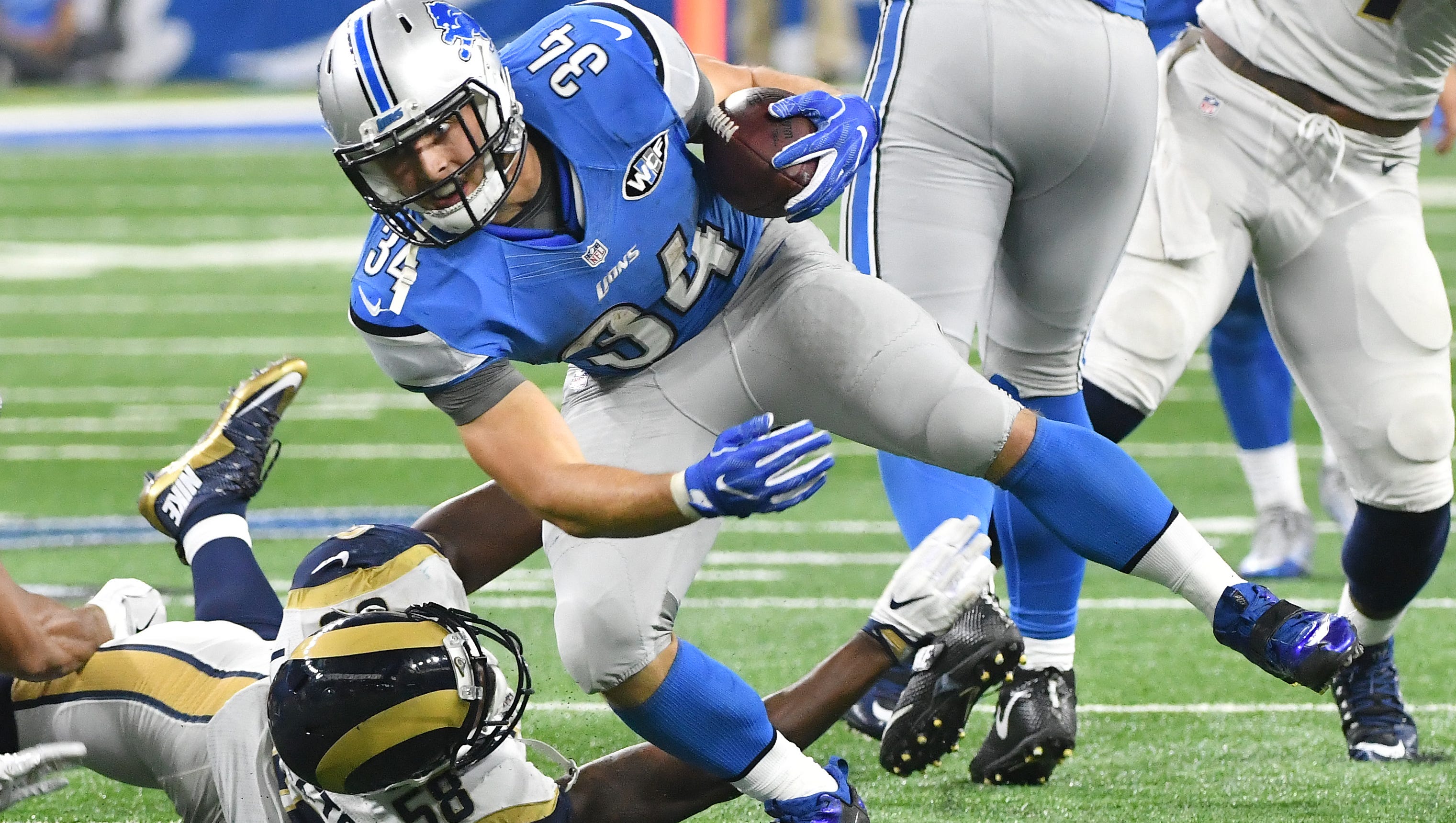 Lions running back Zach Zenner sidesteps the Rams' Cory Littleton on the Lions' winning drive late in the fourth quarter.