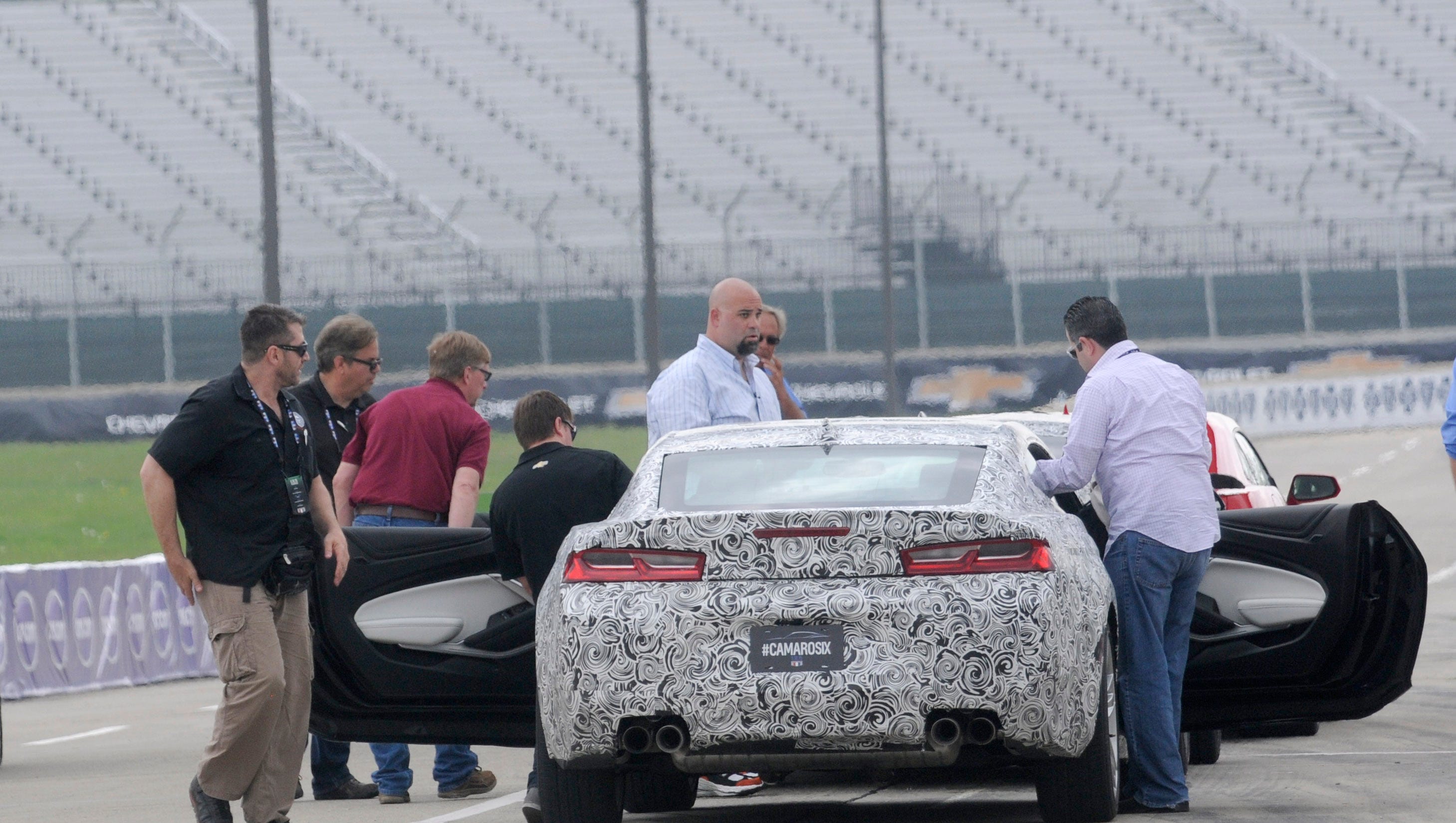Media members prepare to enter the 2016 Camaro mule cars during a test day with the new Chevrolet Camaro on the Grand Prix track at Belle Isle.