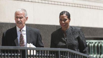 Monica Morgan-Holiefield, right, and defense lawyer Steve Fishman, left, leave federal court during a recent hearing.