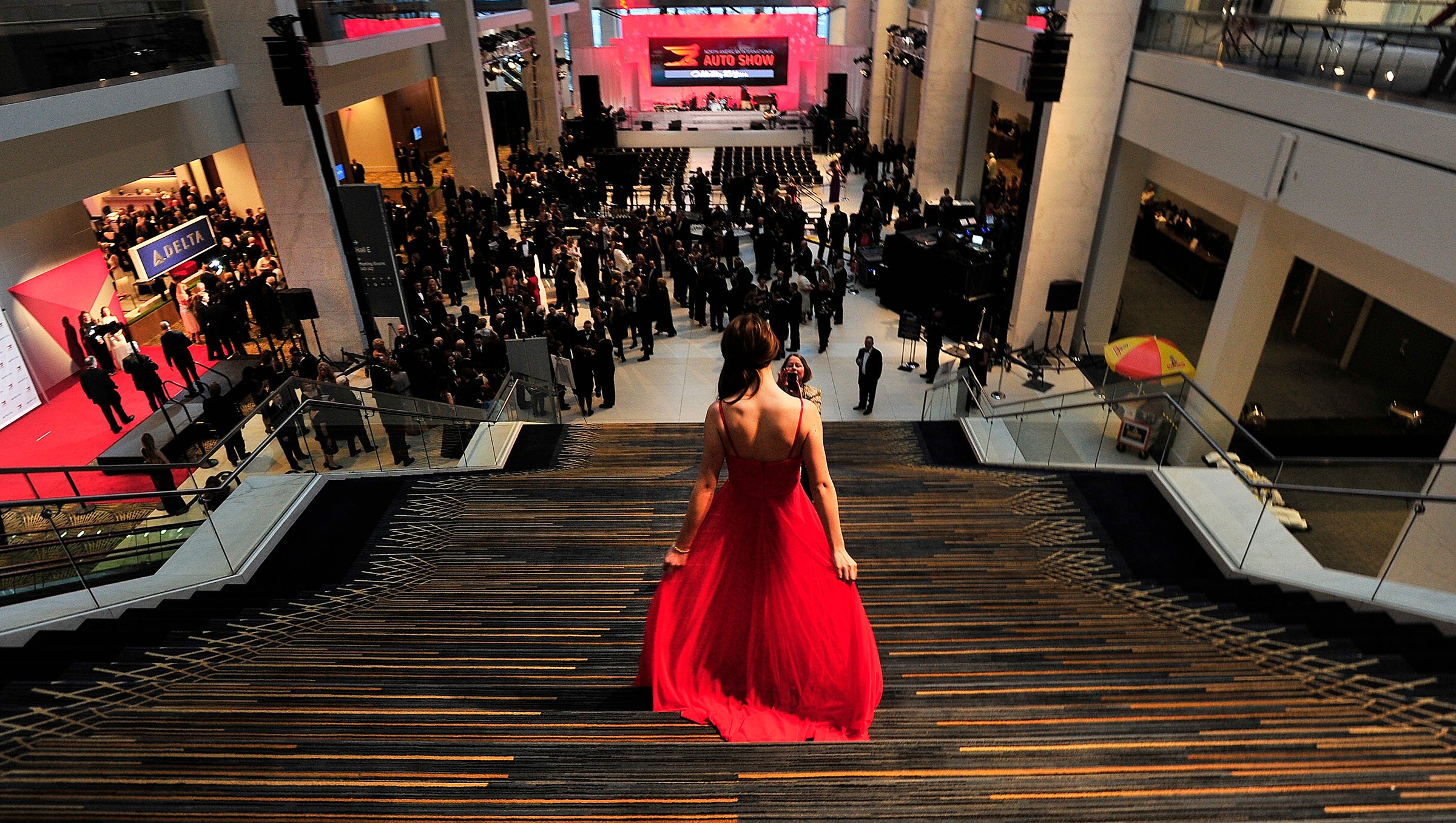 Cara Wood walks down the steps leading to the atrium  before the ribbon cutting ceremony for the Charity Preview for the North American International Auto Show at the Cobo Center on Jan. 17, 2014.