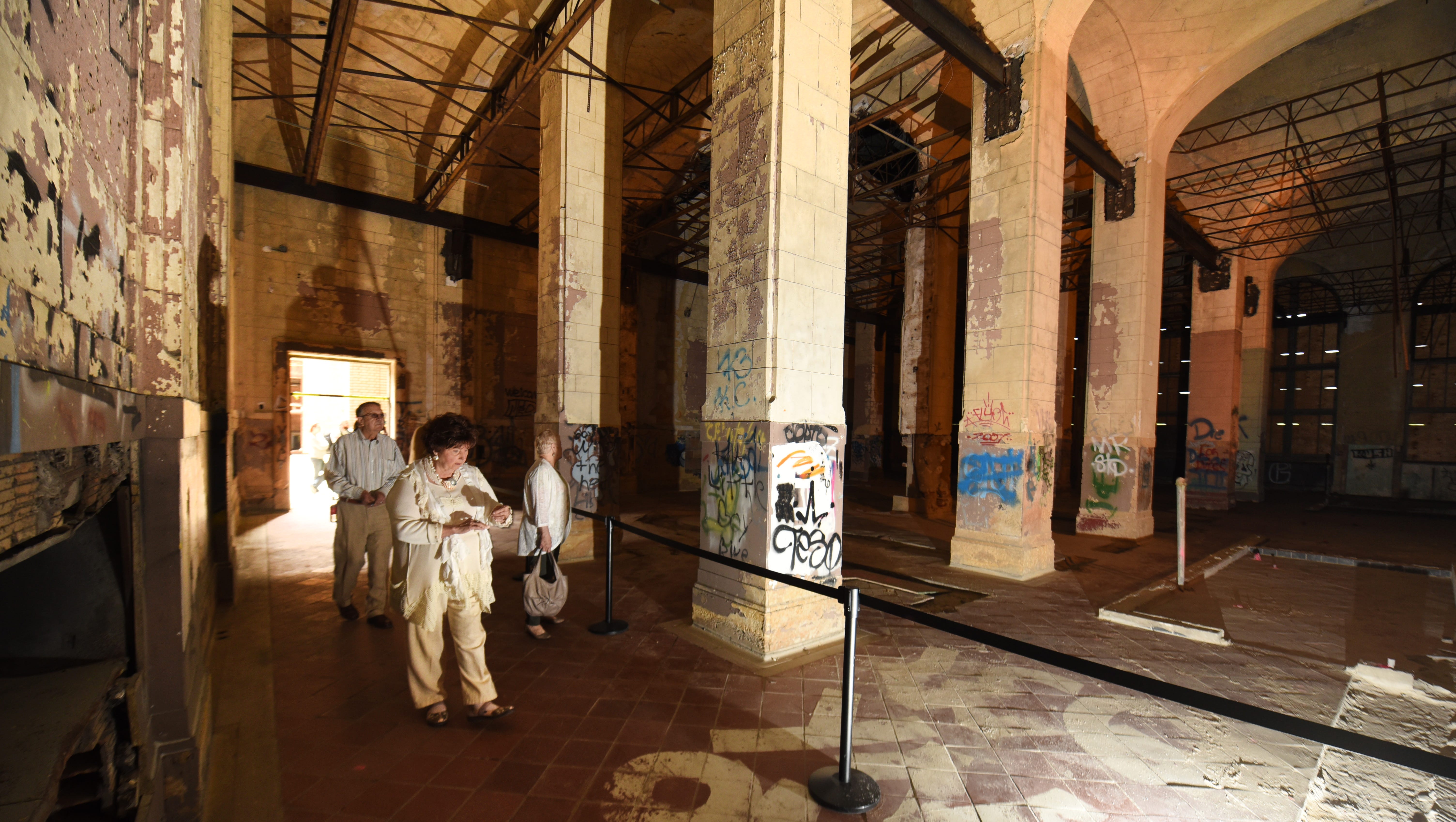 People walk through a former restaurant area Friday in the Michigan Central Train Depot.