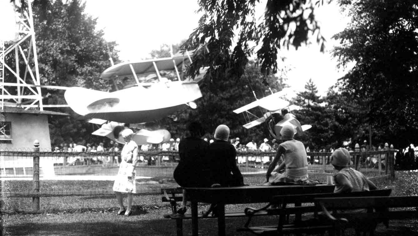 Visiters relax and watch the amusement rides on Boblo island, circa 1920s.
