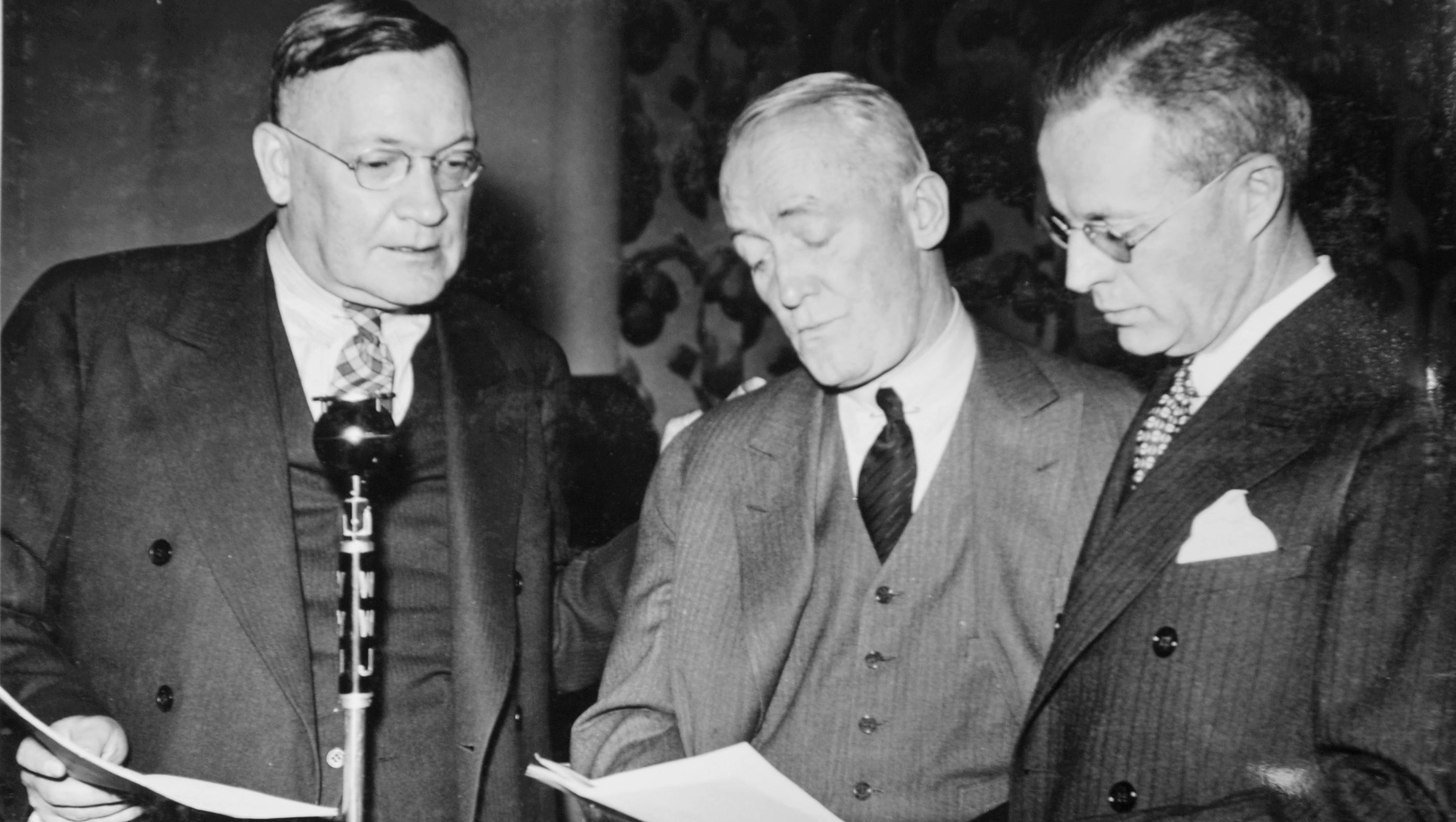 Detroit News columnist George Stark, left, broadcasts an interview with playwright/ composer/ performer George M. Cohan, center, in 1936.