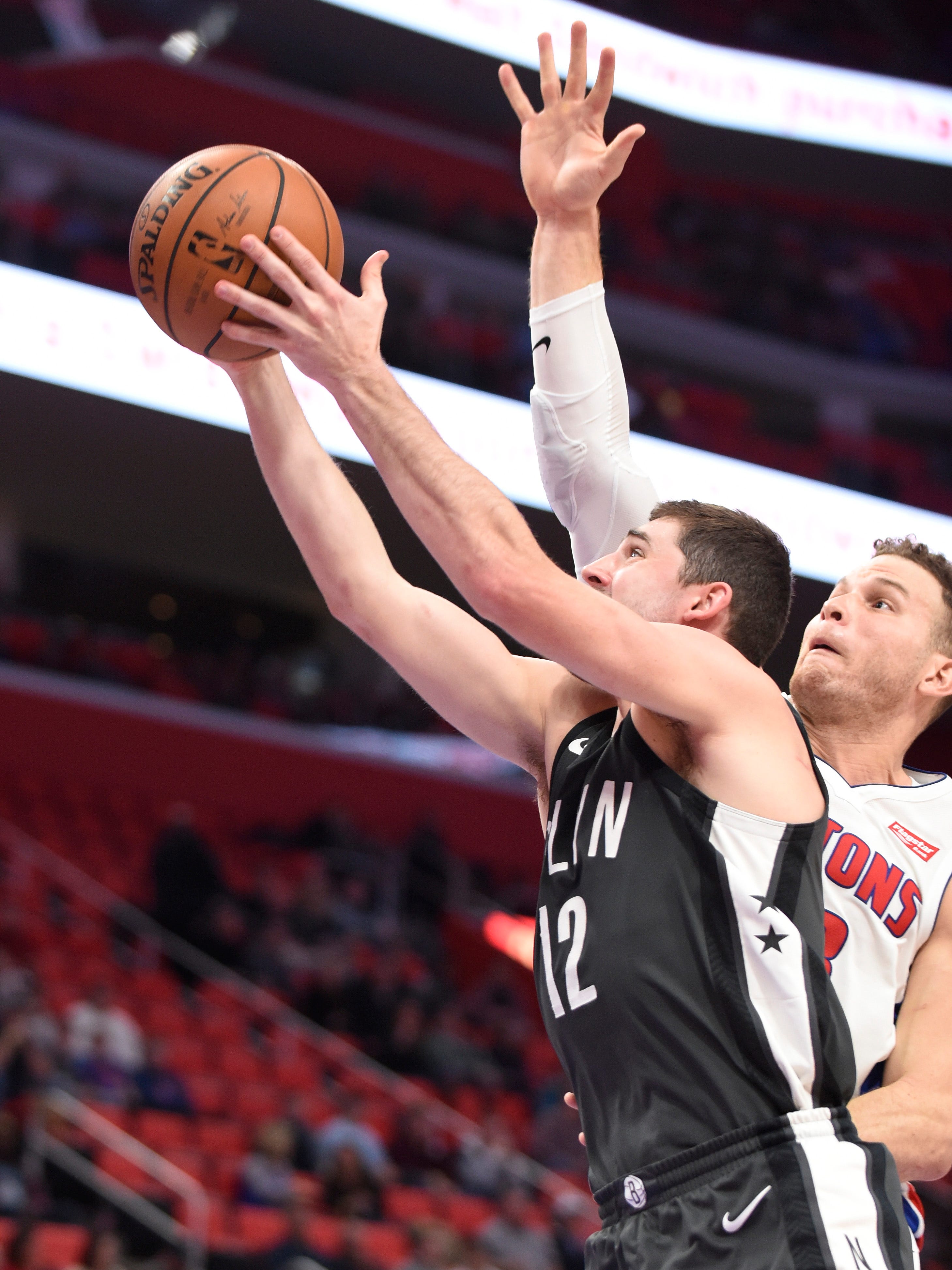 Nets' Joe Harris scores with Pistons' Blake Griffin defending in the first quarter.