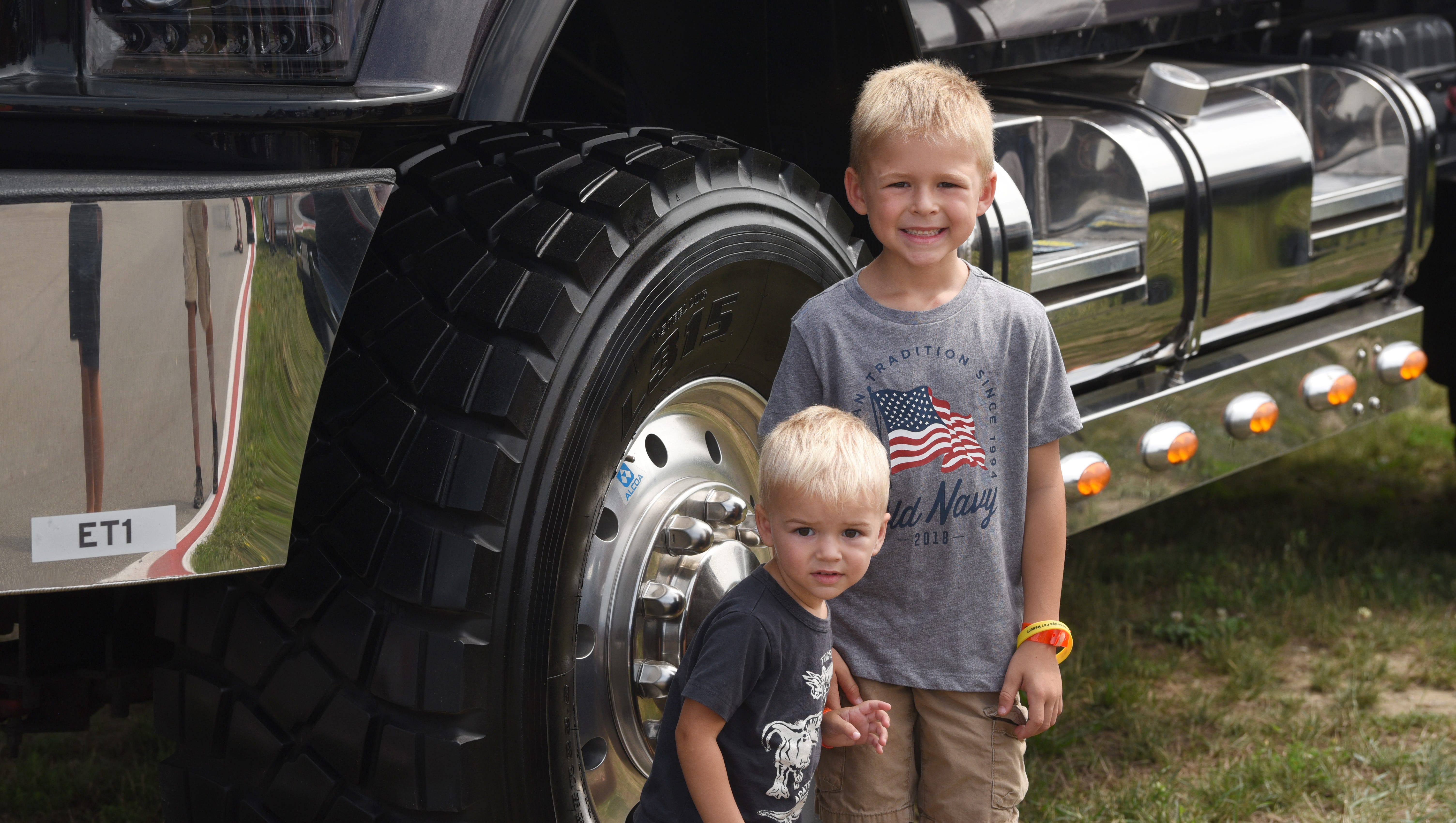 Luke Hawes (left) 2, and his brother Eli Hawes, 5, of New Baltimore, stand next to the U.S. Army off-road truck at the Roadkill Nights in Pontiac on Saturday, August 11, 2018