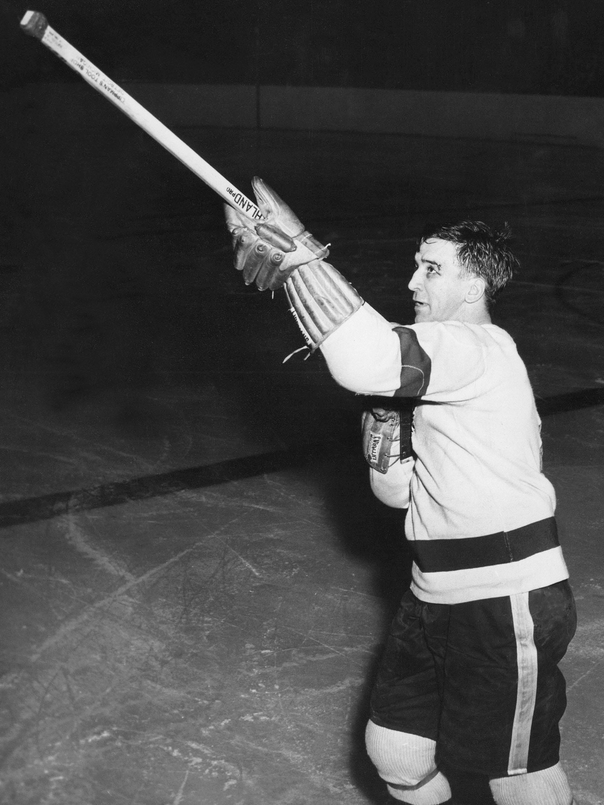Ted Lindsay uses his stick to shoot the crowd after ignoring a death threat and scoring the overtime winner in Game 3 of the 1956 Stanley Cup semifinal in Toronto.