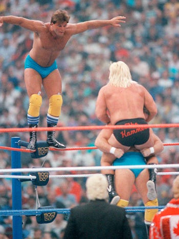 The Rougeau Brothers double-team Greg "The Hammer" Valentine in their tag-team match, which was fifth on the card.