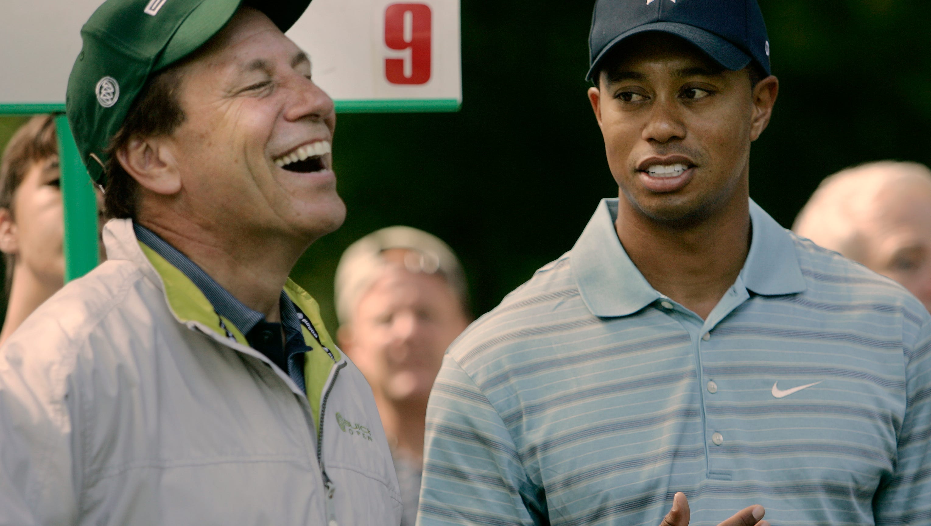 Tiger Woods and Michigan Staet basketball coach Tom Izzo play in the Buick Open pro-am in 2005.