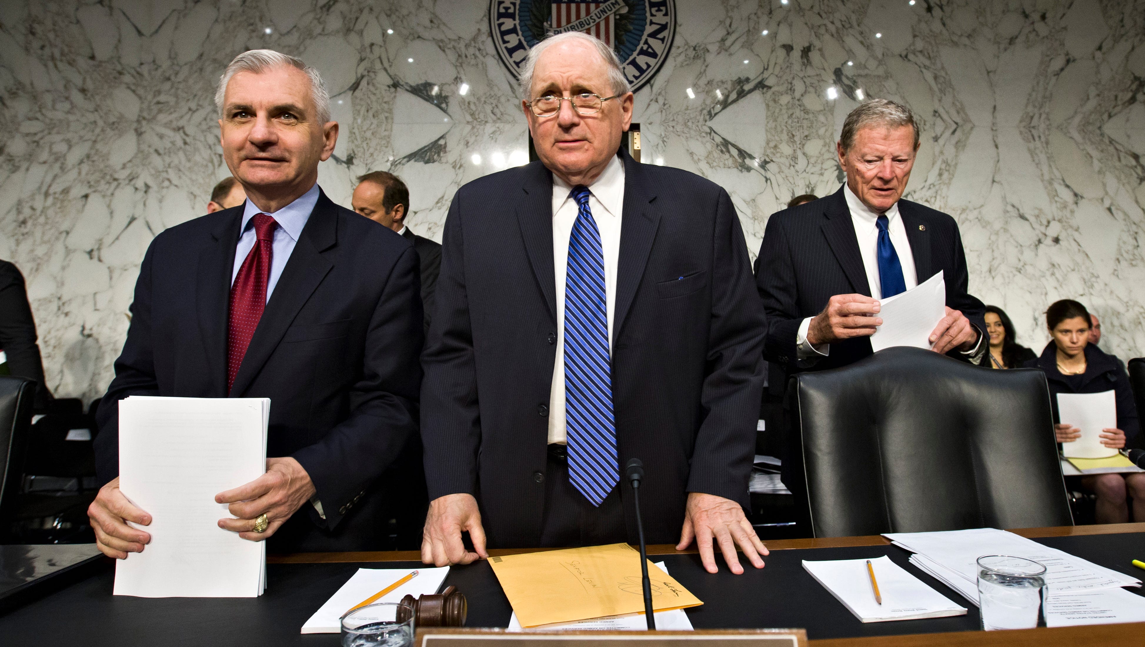 Senate Armed Services Committee Chairman Sen. Carl Levin flanked by Sen. Jack Reed, D-R.I., left, and the committee's ranking Republican, Sen. James Inhofe, R-Okla., arrive on Capitol Hill Tuesday, June 4, 2013, for the start of a hearing as Congress investigates the growing epidemic of sexual assaults within the military.