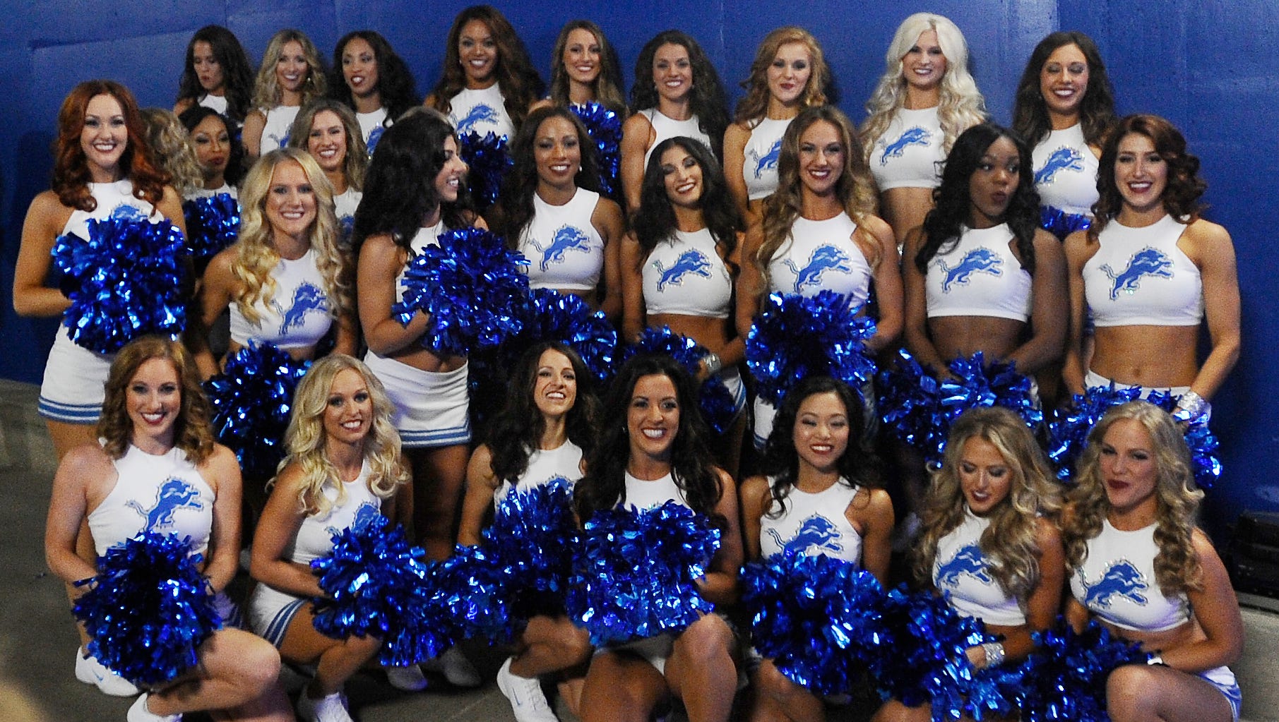 Lions cheerleaders pose for pictures in the tunnel to the field before the game.