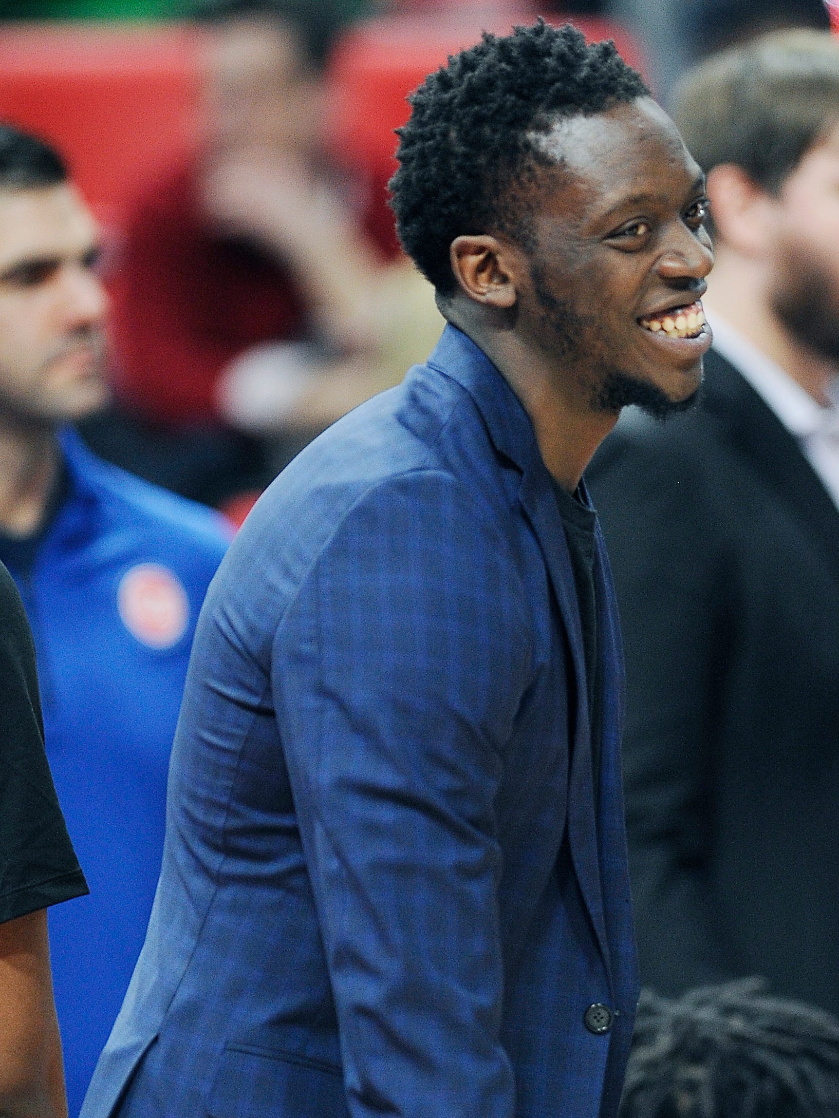 Pistons' injured guard Reggie Jackson chat with teammates during a timeout in the second quarter.
