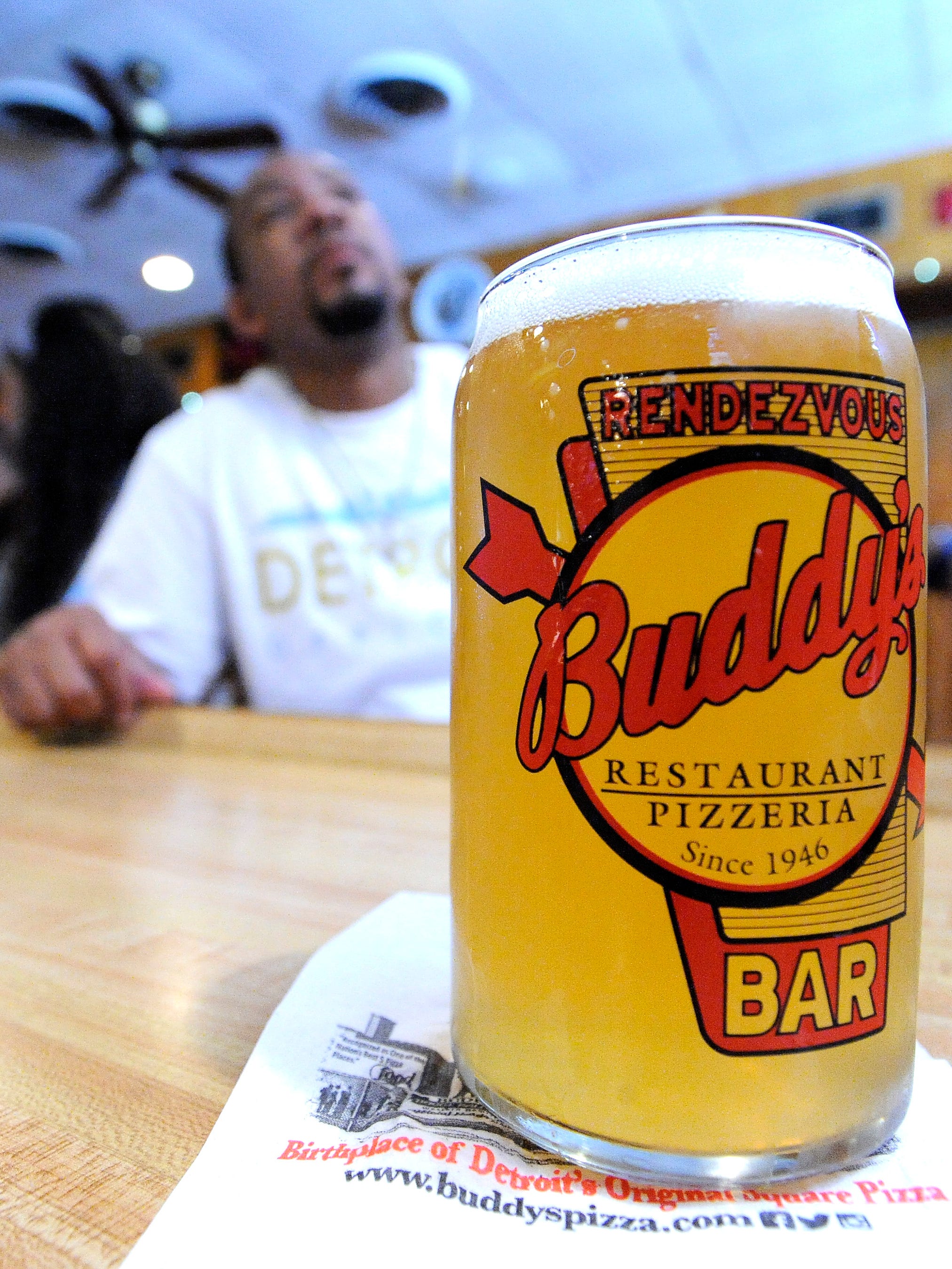 Regular customer Nate Harris, 40, of Detroit, sits behind a pint of Buddy Brew at the Conant location in 2016.