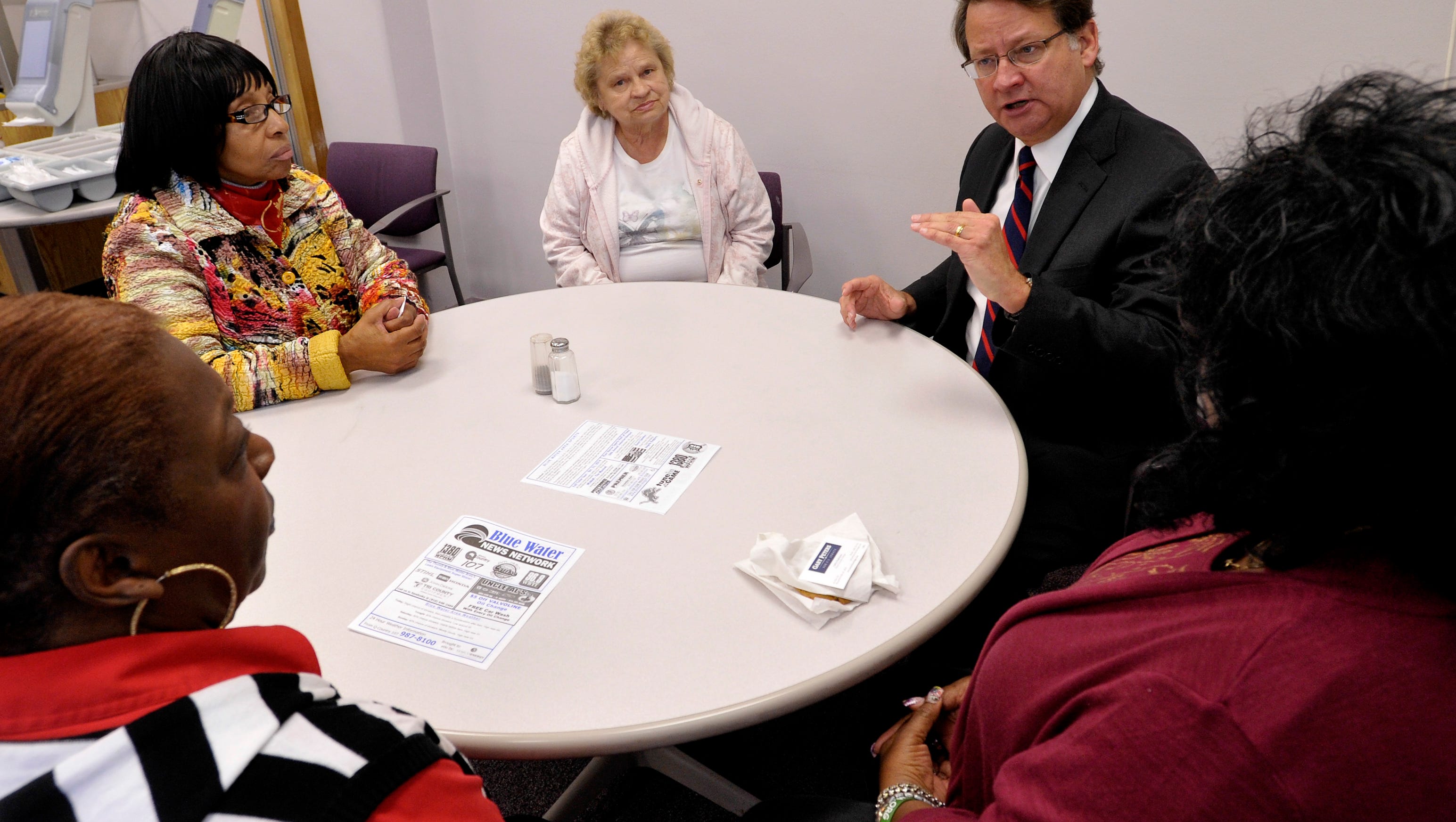 U.S. Congressman Gary Peters, left, talks with Sandi King, left, 73, Joyce Snyder, 66, Delores Krul, 73, and Fredricka Collier, 65, all of Port Huron and all foster grandmothers.