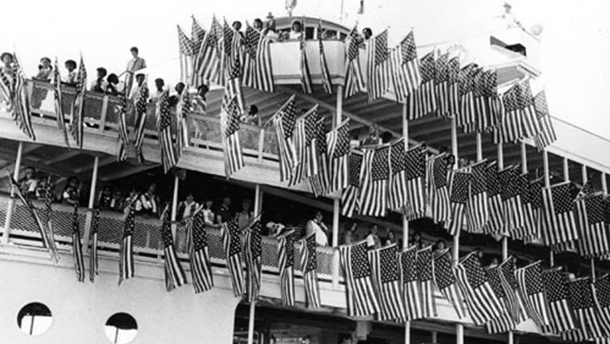 American flags grace the Ste. Claire during a Girl Scout outing on July 4, 1981.