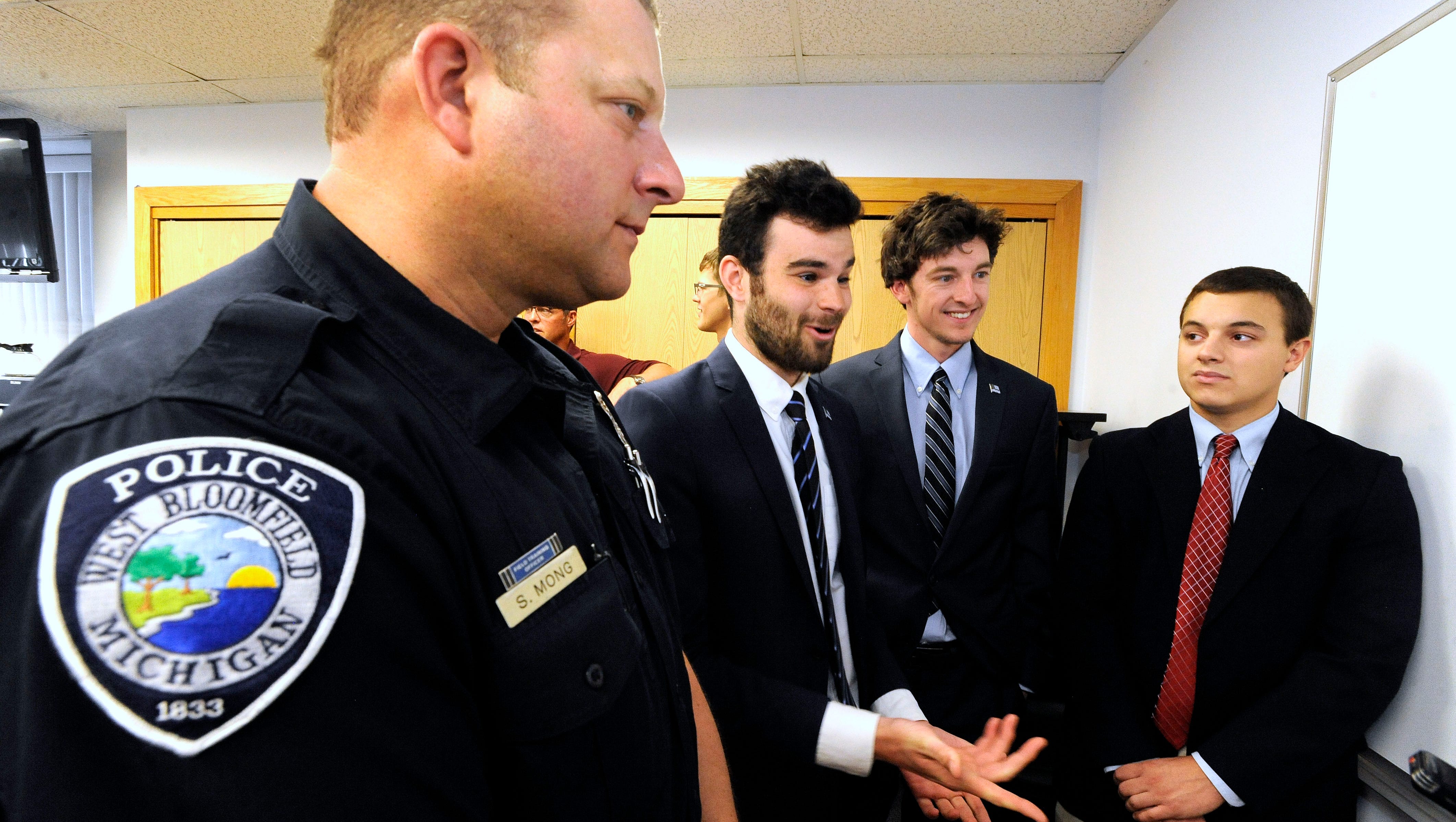 From left, West Bloomfield Twp. police officer Scott Mong, Thin Blue Line USA founder and president Andrew Jacob, vice president Pete Forhan and Mong's son, Devin Mong, 18, talk with The Detroit News after Devin, who is going to Virginia Tech, received a $2,500 scholarship check. Four children of West Bloomfield Twp. police officers each received $2,500 college scholarship checks,  May 18, 2017, during a ceremony at the department as attendees remember police officers who gave their lives in the line of duty during National Police Week.