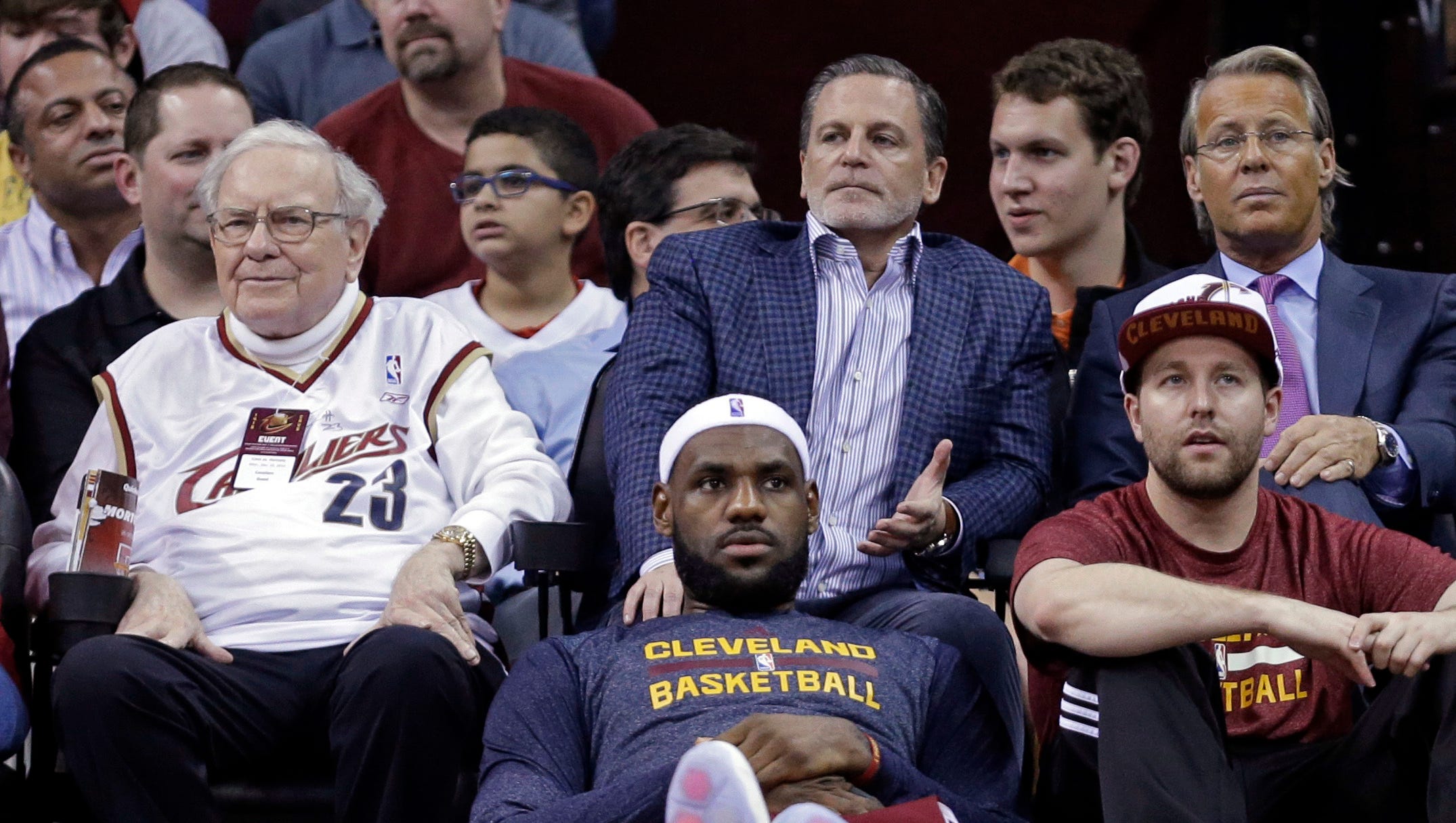 Dan Gilbert sits behind the star of his franchise, LeBron James, during a game in December.
