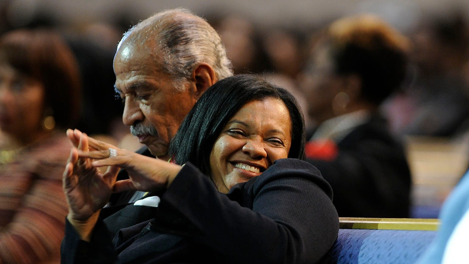 Monica Conyers cozies up to her husband while The Legendary Four Tops sing "Ain't No Woman (Like the One I Got)" during his tribute at Greater Grace Temple Church in Detroit in 2013.