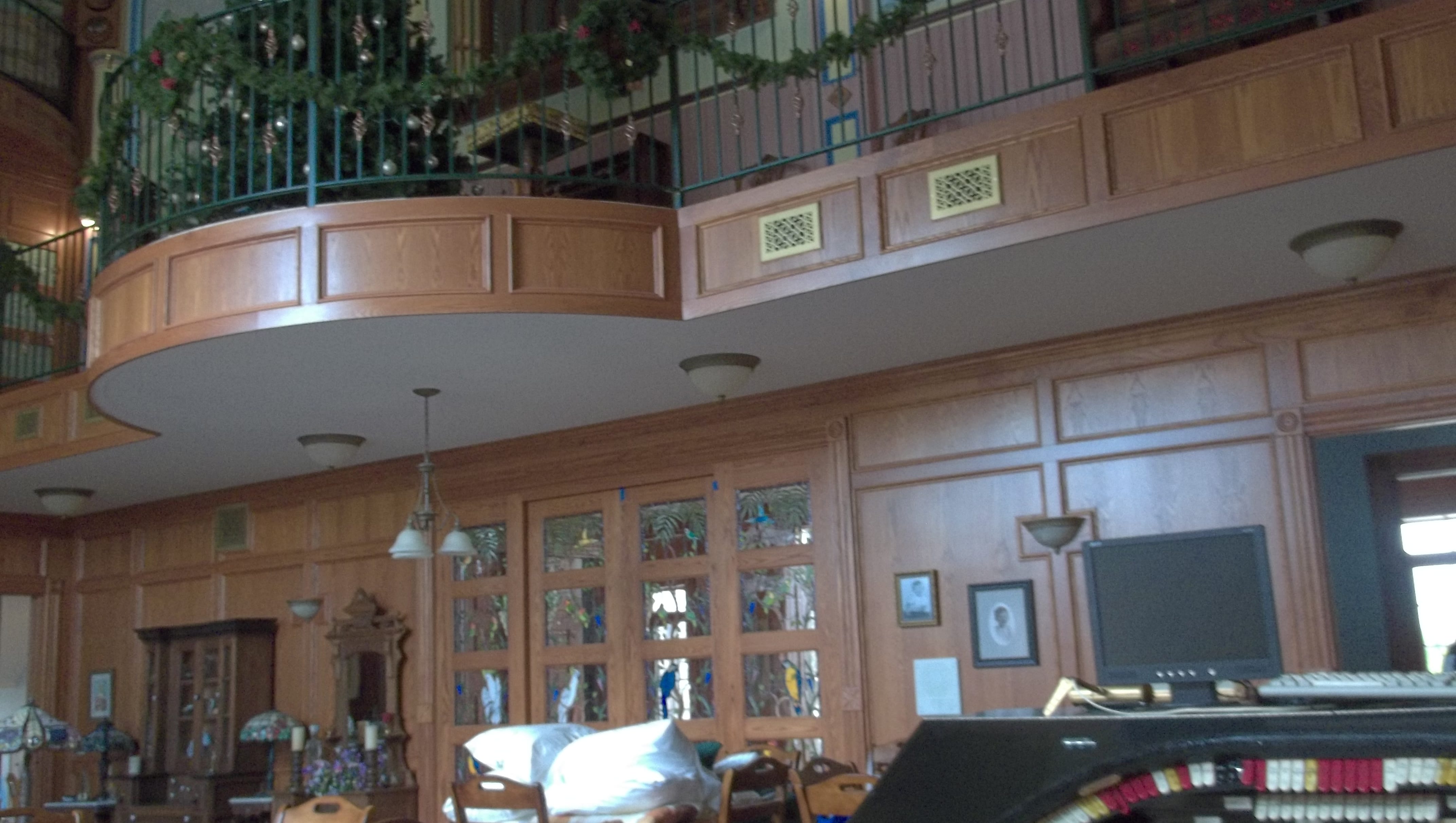 A great room includes wood paneling, a pipe organ and a mezzanine.