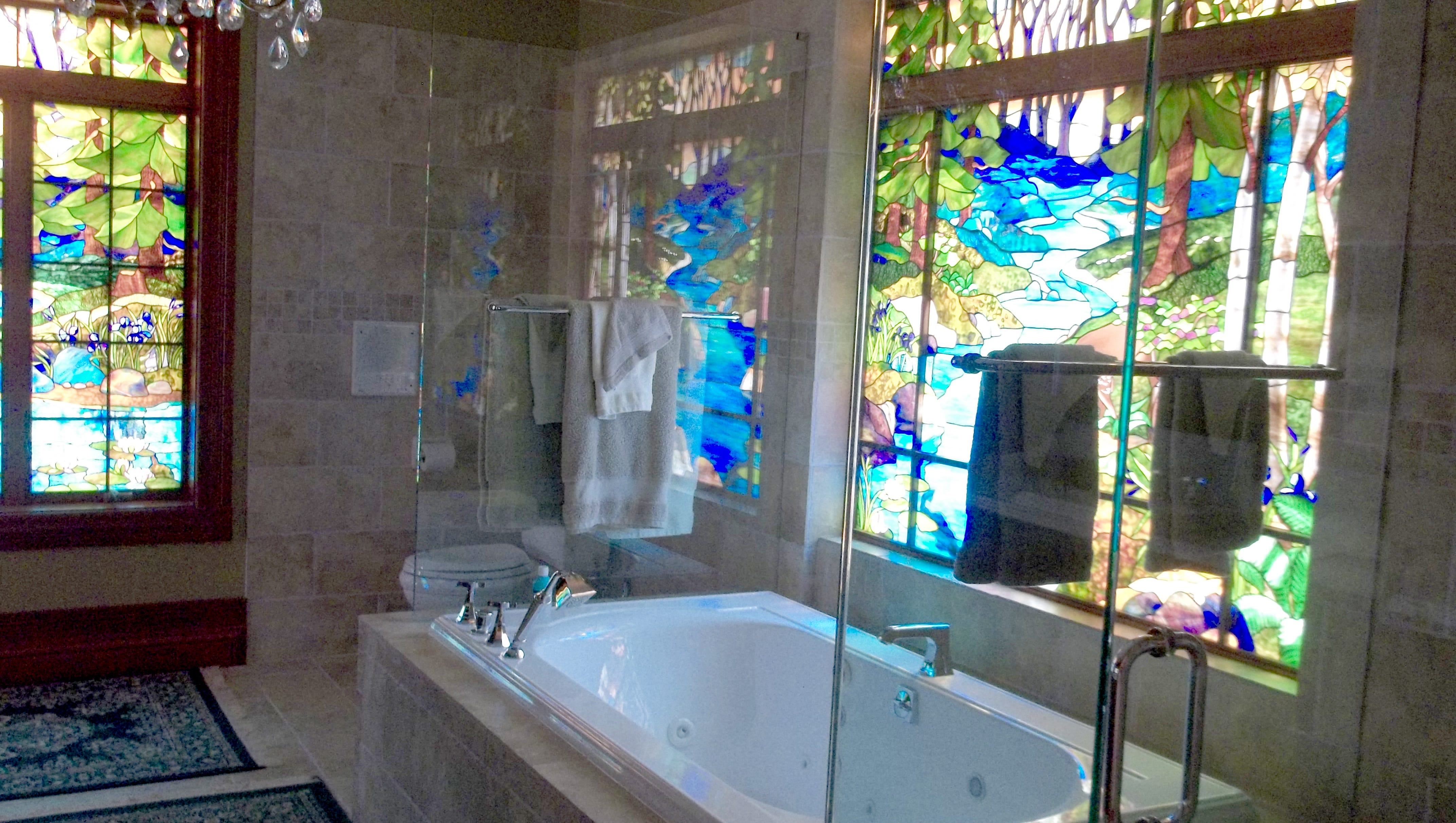 One of the bathrooms features stained glass windows.