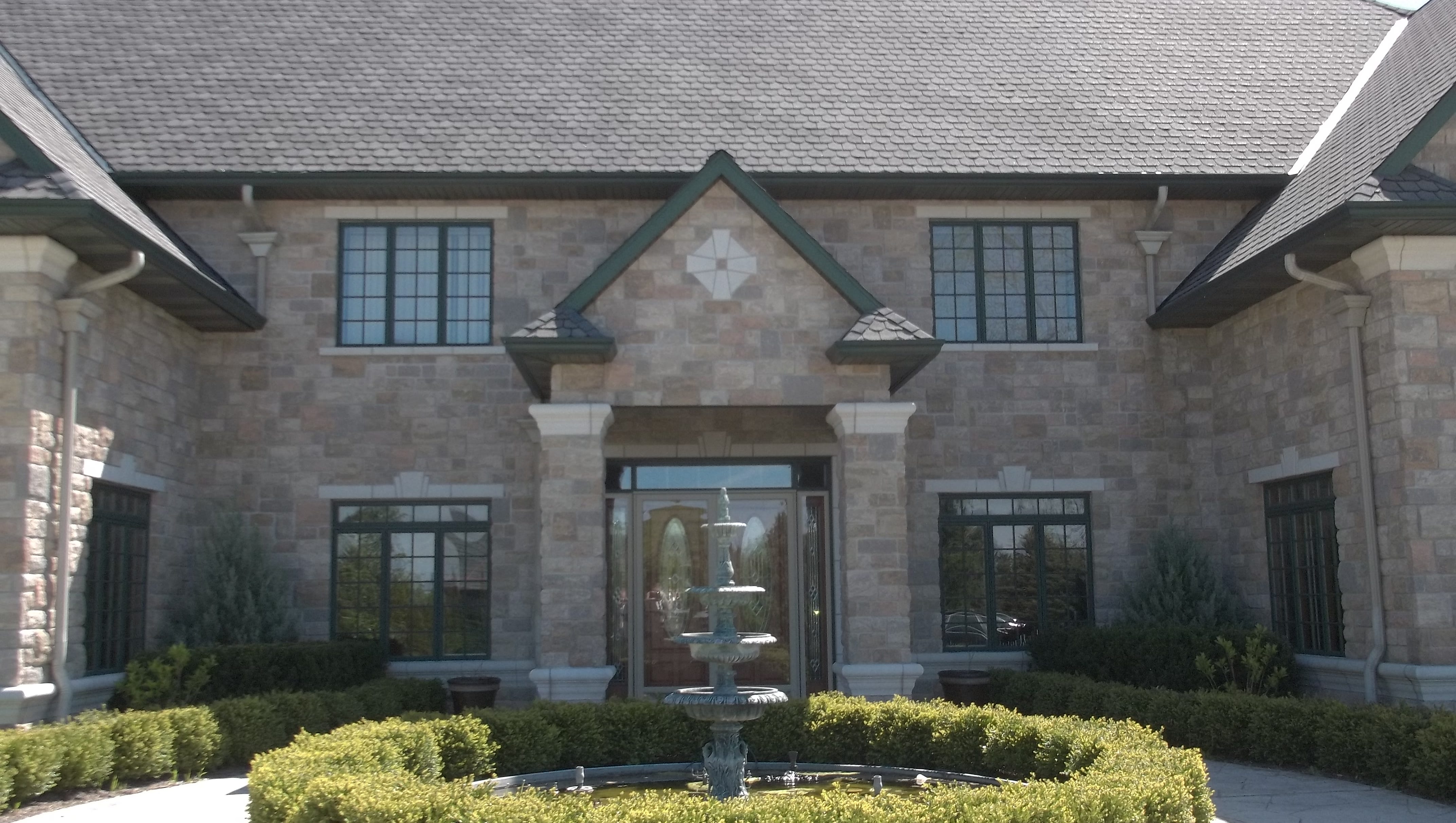 The front entrance to Rev. Wehrle's mansion is shown. The house has an elevator, indoor swimming pool and wine room. Among the furnishings are three pipe organs.