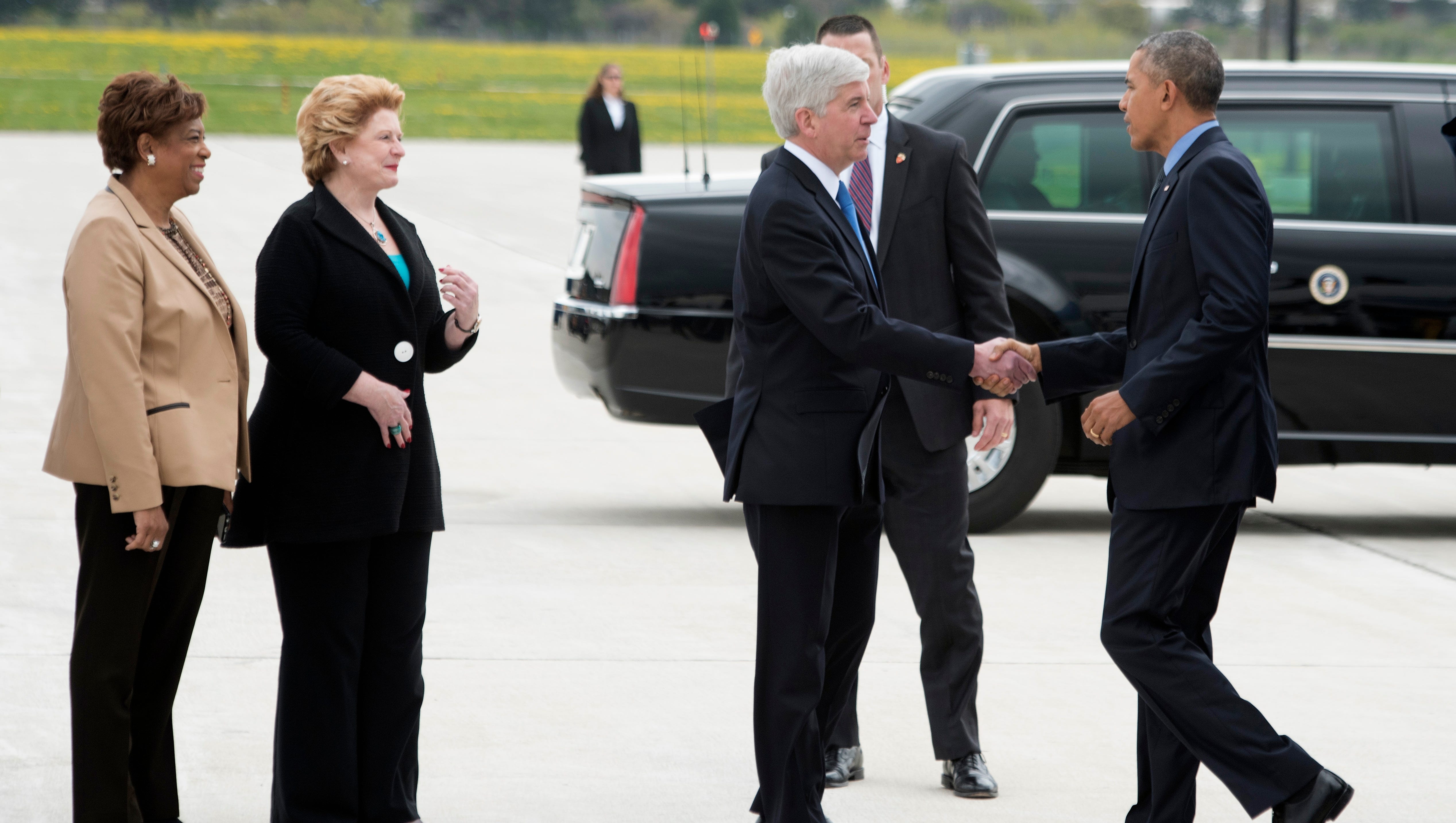 Rep. Brenda Lawrence, from left, Sen. Debbie Stabenow and Gov. Rick Snyder greet President Obama at Bishop International Airport.