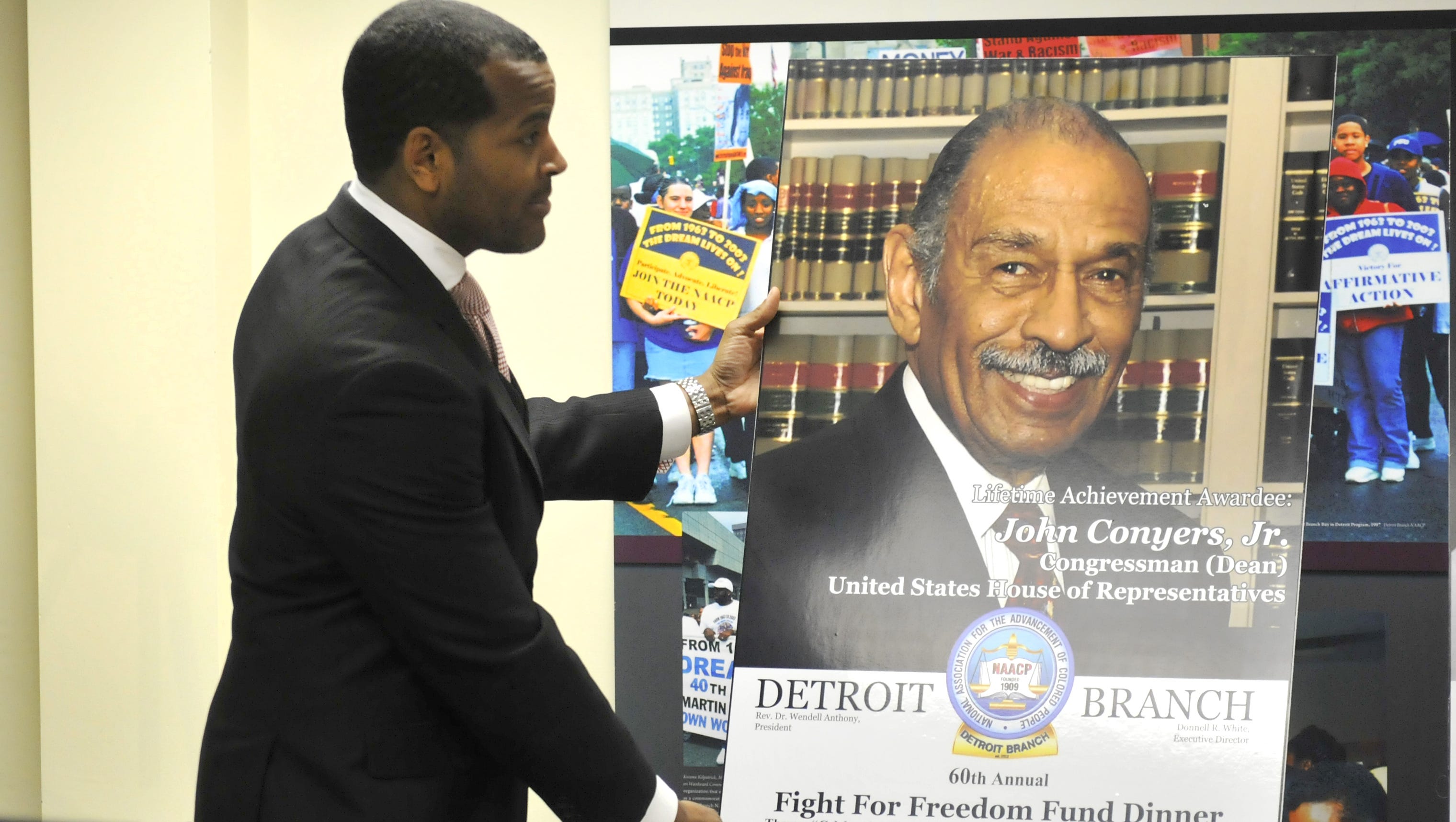 Donnell White, executive director of NAACP Detroit, unveils a poster of Conyers, naming him the honoree for the Lifetime Achievement Award at the 60th Annual Fight for Freedom Fund Dinner at Cobo Center in 2015.