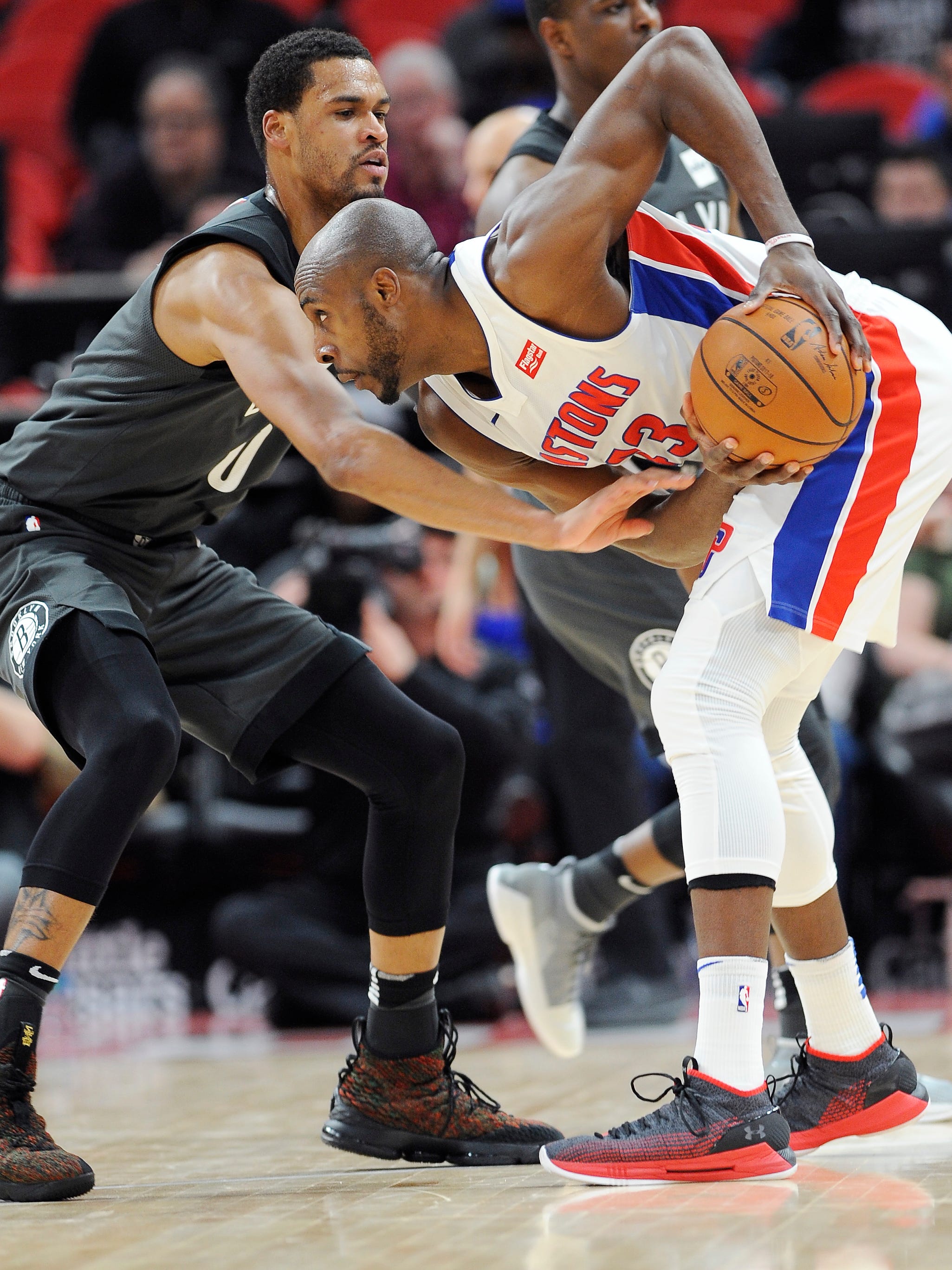Pistons' Anthony Tolliver looks for room around Nets' James Webb III in the second quarter.