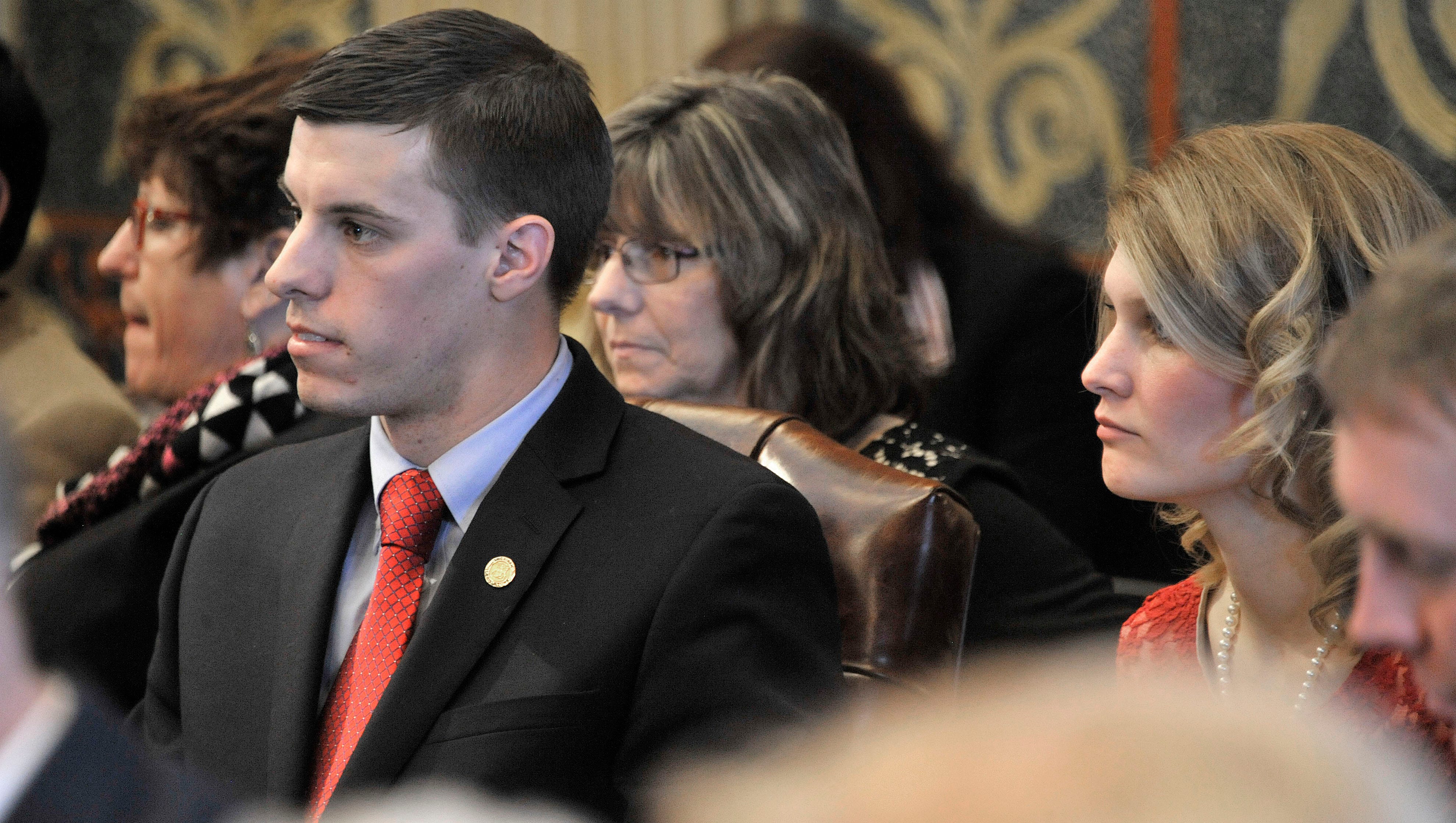 Rep. Lee Chatfield, R-Levering, sits with his wife Stephanie, far right, after taking his oath of office.