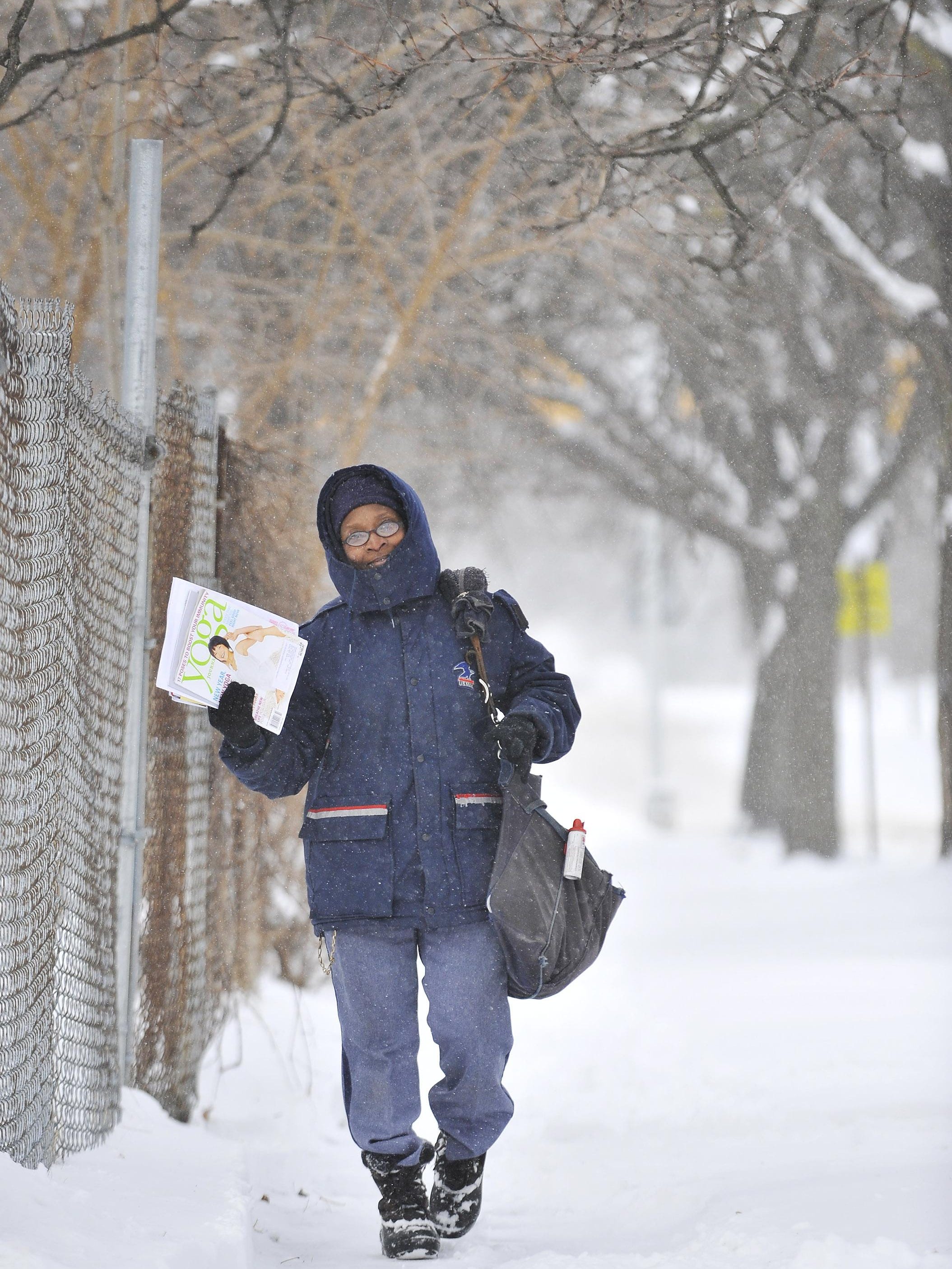 Juana Winfrey, a 27 year veteran of the USPS delivers mail on West Grand Blvd. in Detroit on Jan 2, 2014.