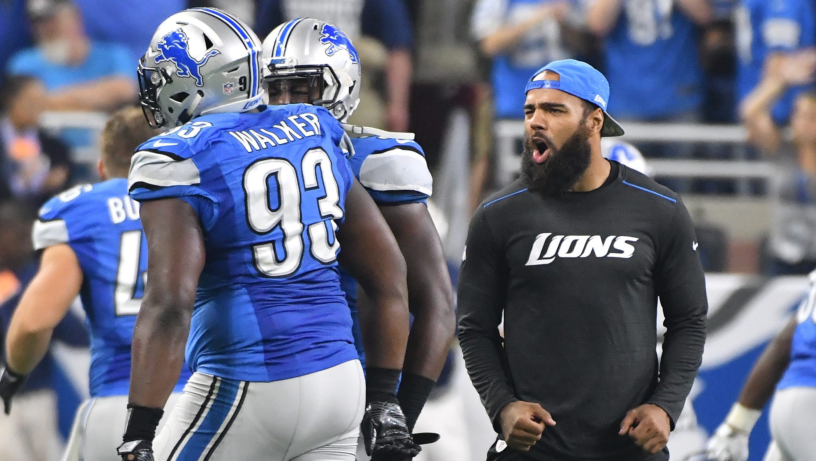 Injured linebacker DeAndre Levy cheers on teammate Tyrunn Walker after Detroit defense stopped the Rams on 4th and 1 at the end of the first half.