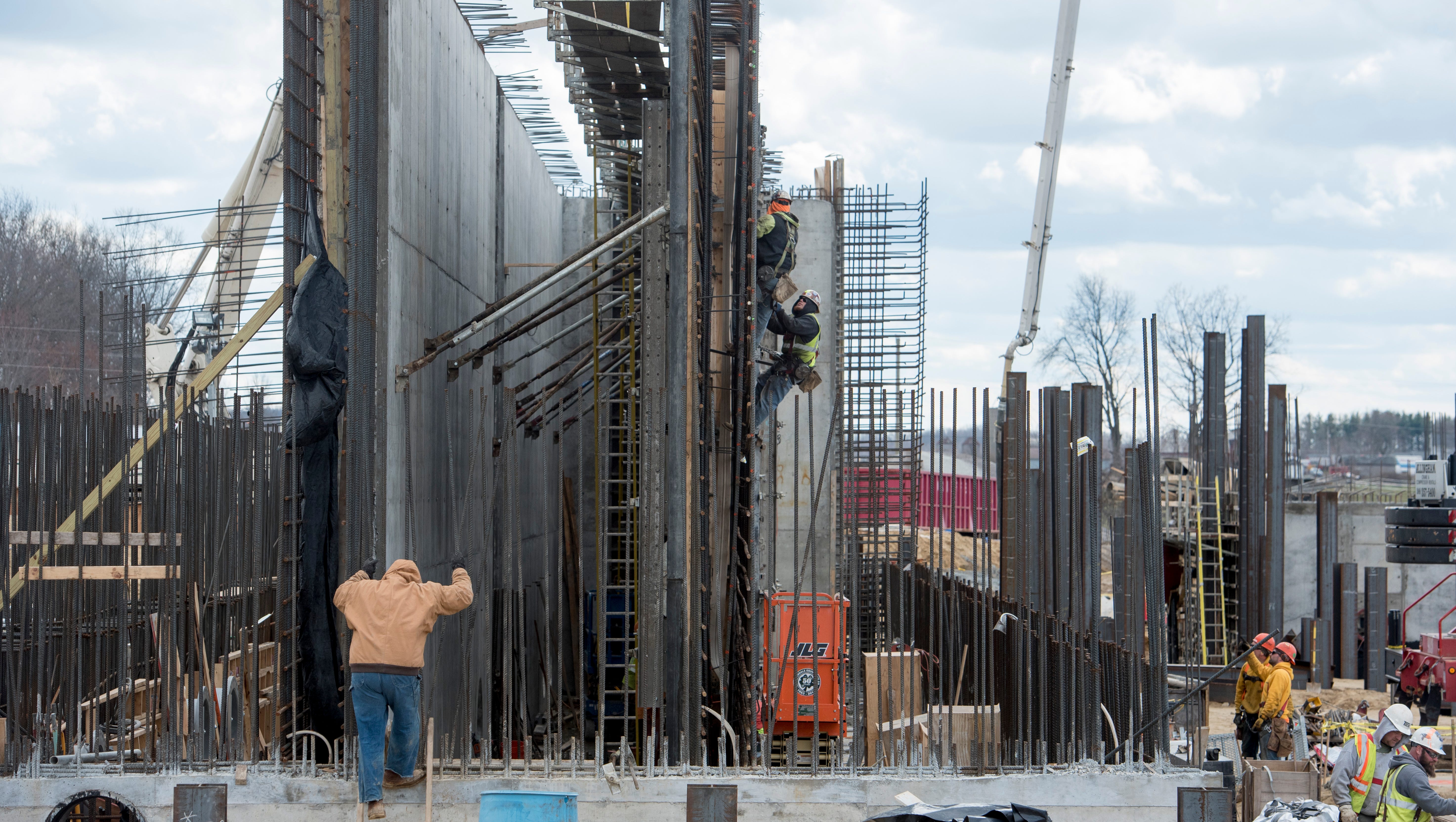Laborers work on a wall at the construction site of the new Karegnondi Water Authority water treatment plant.