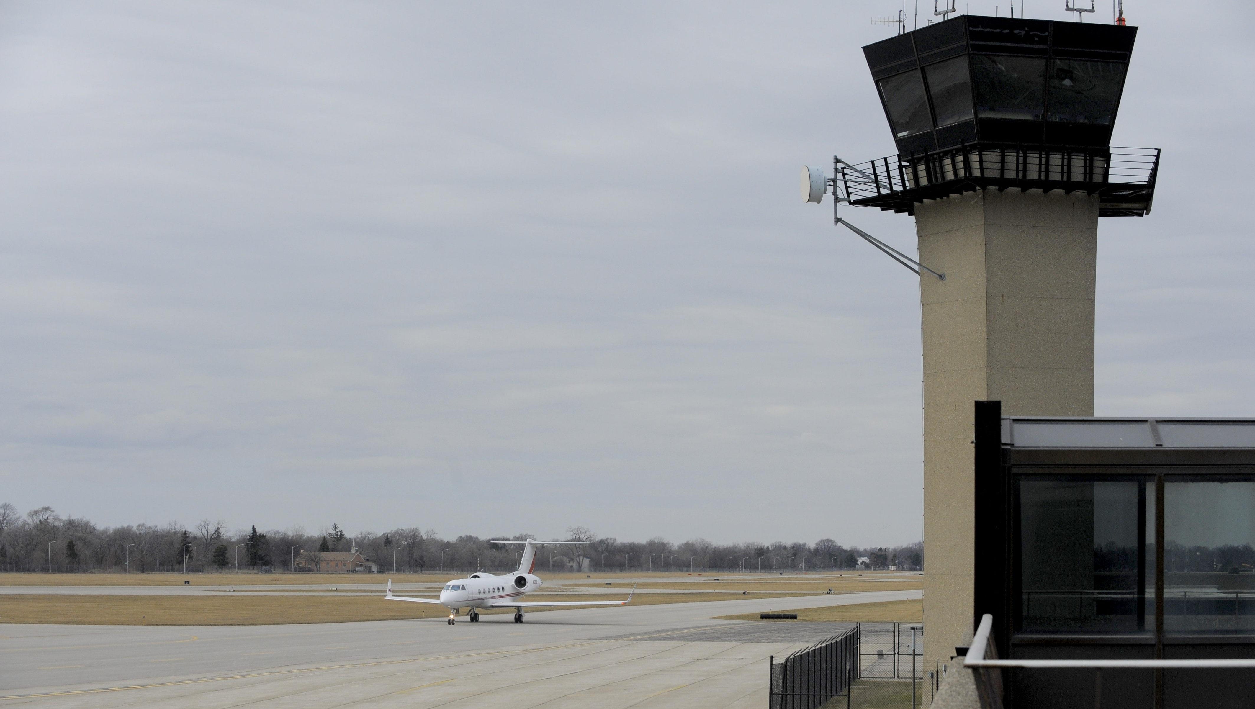 A plane taxis past the Detroit City Airport tower in this file photo from Friday March 20, 2015.