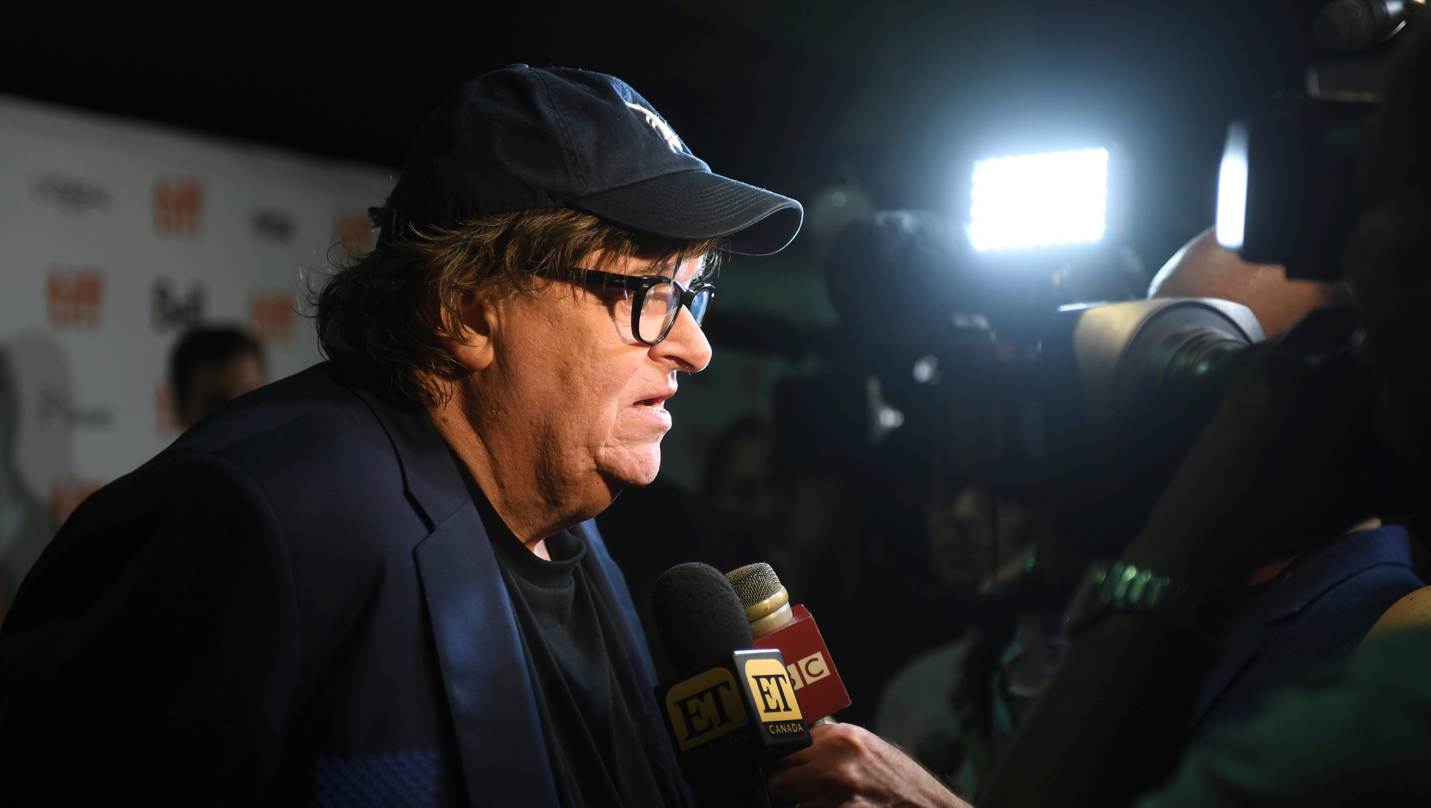 Michael Moore speaks with journalists as he attends the premiere for "Fahrenheit 11/9" on day 1 of the Toronto International Film Festival at the Ryerson Theatre on Thursday, Sept. 6, 2018, in Toronto.