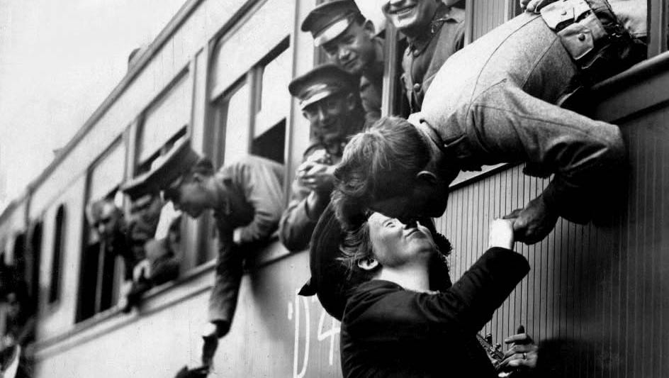 A World War I solider tries to steal one last kiss as the train leaves the depot.