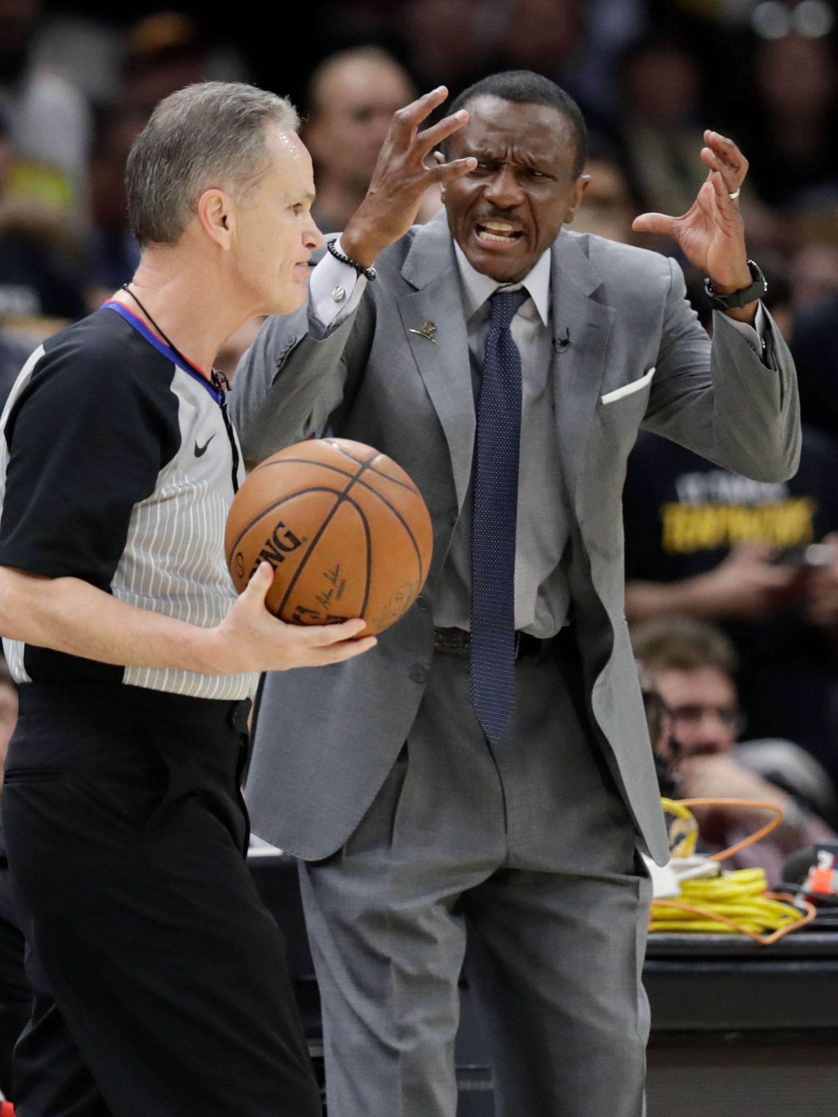 Toronto Raptors head coach Dwane Casey complains to official Mike Callahan in the first half of Game 3 of an NBA basketball second-round playoff series game against the Cleveland Cavaliers, Saturday, May 5, 2018, in Cleveland.