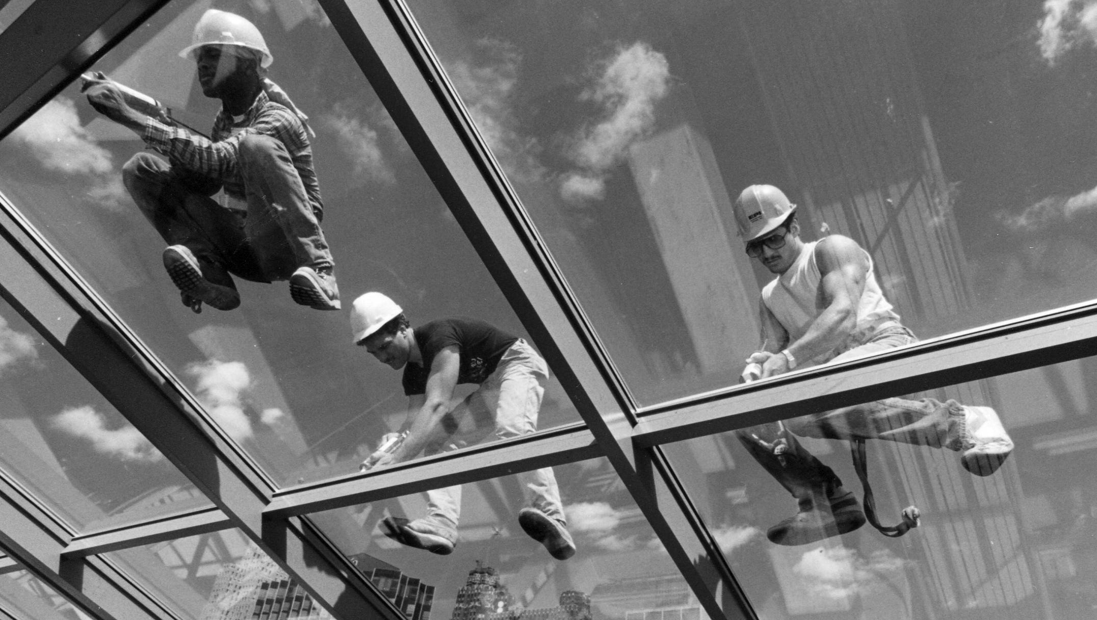 Construction workers complete the glass roof on Sept. 10, 1987.