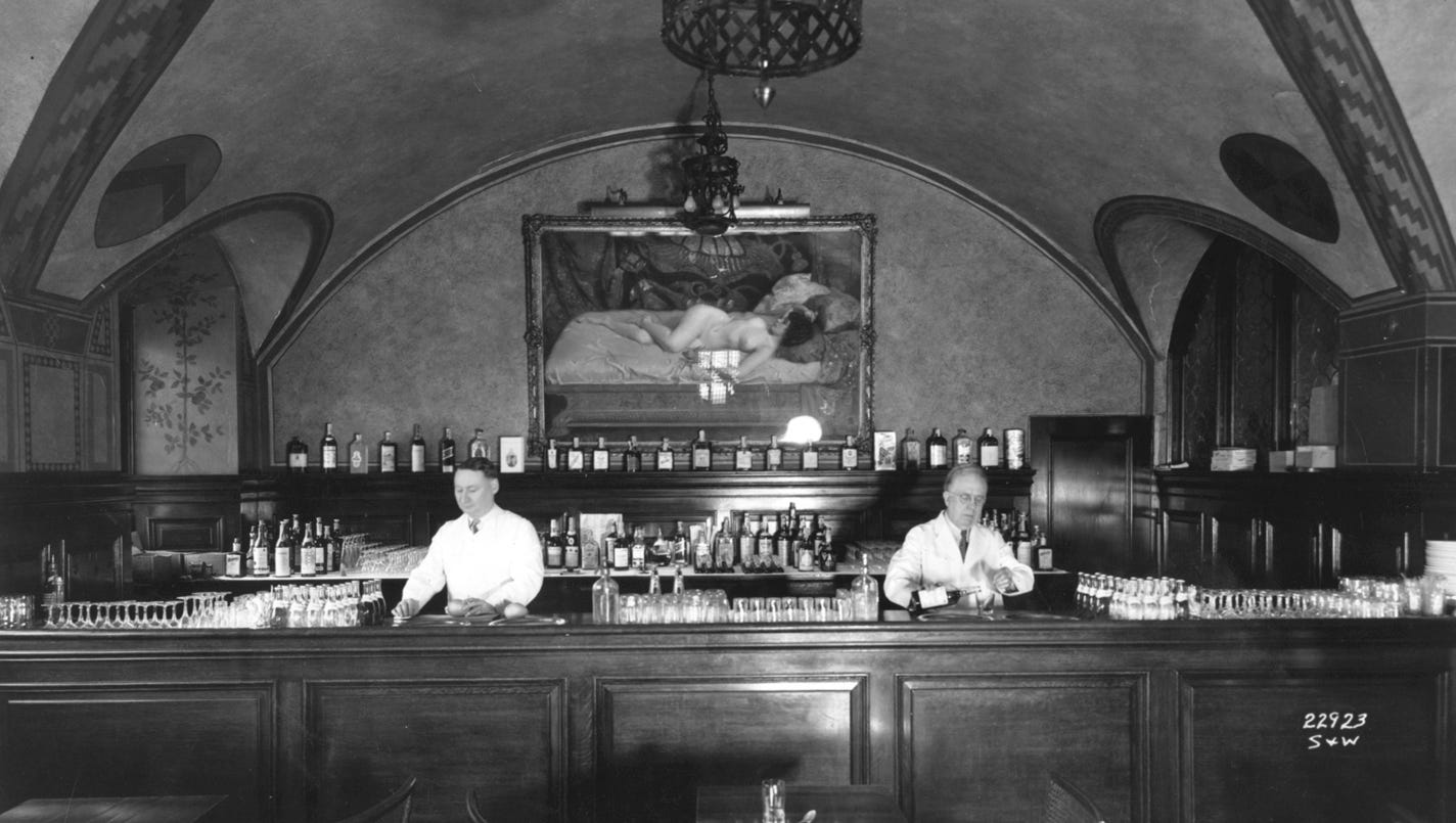 Two bartenders work behind the bar and grill at the Detroit Athletic Club.