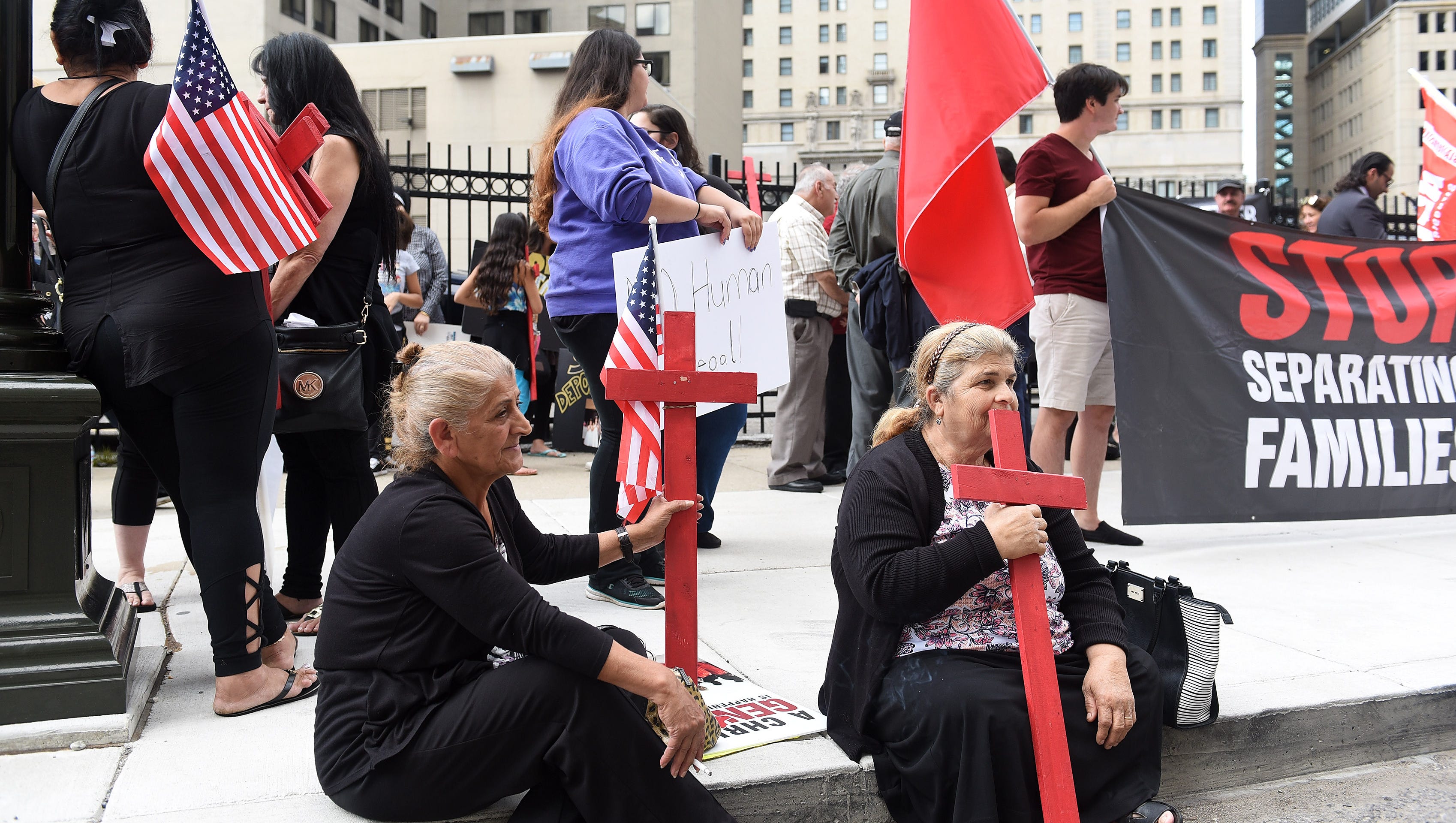 Sabria Pasha, left, of Sterling Heights, whose son is being detained, sits with Khiton Isaq of Troy at a rally in support of people who have been detained by ICE.